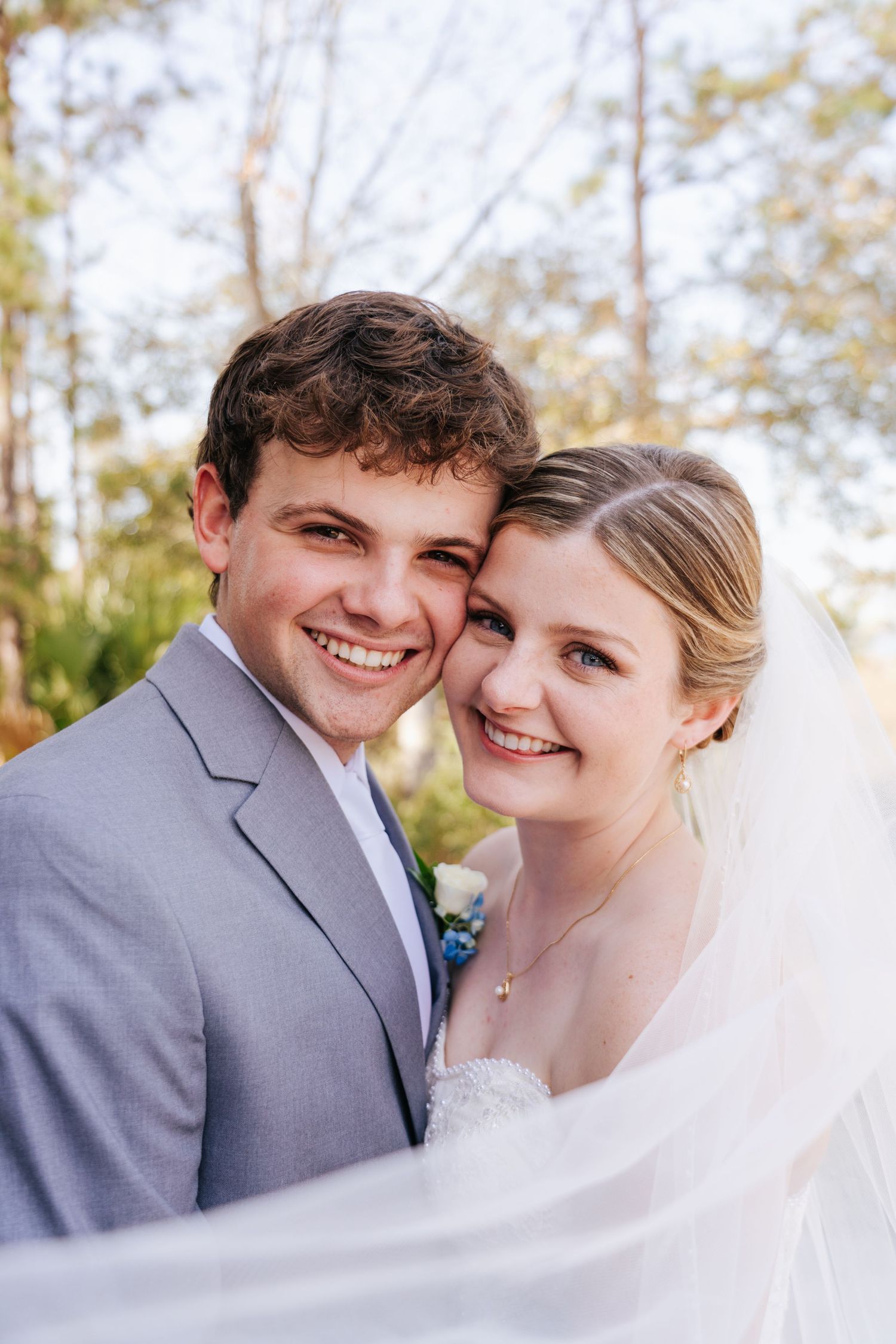 Romantic wedding portraits with the couple sharing intimate moments under a veil.