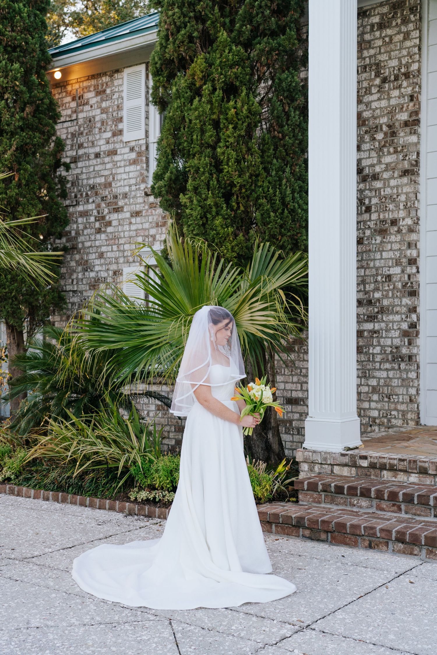A bridal portrait series showcases a white gown against classic brick architecture and palm trees.
