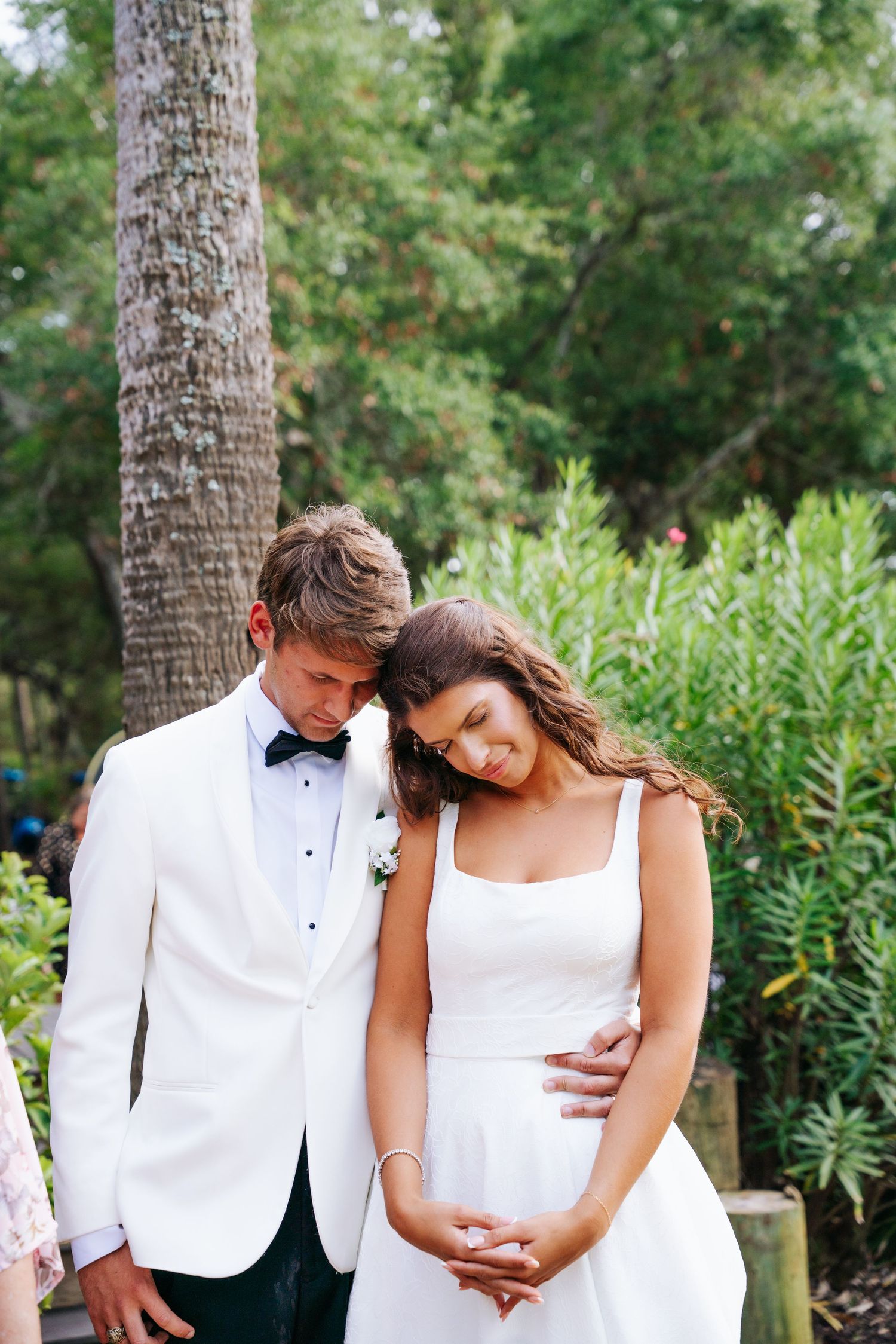 A romantic moment of prayer at a wedding reception.