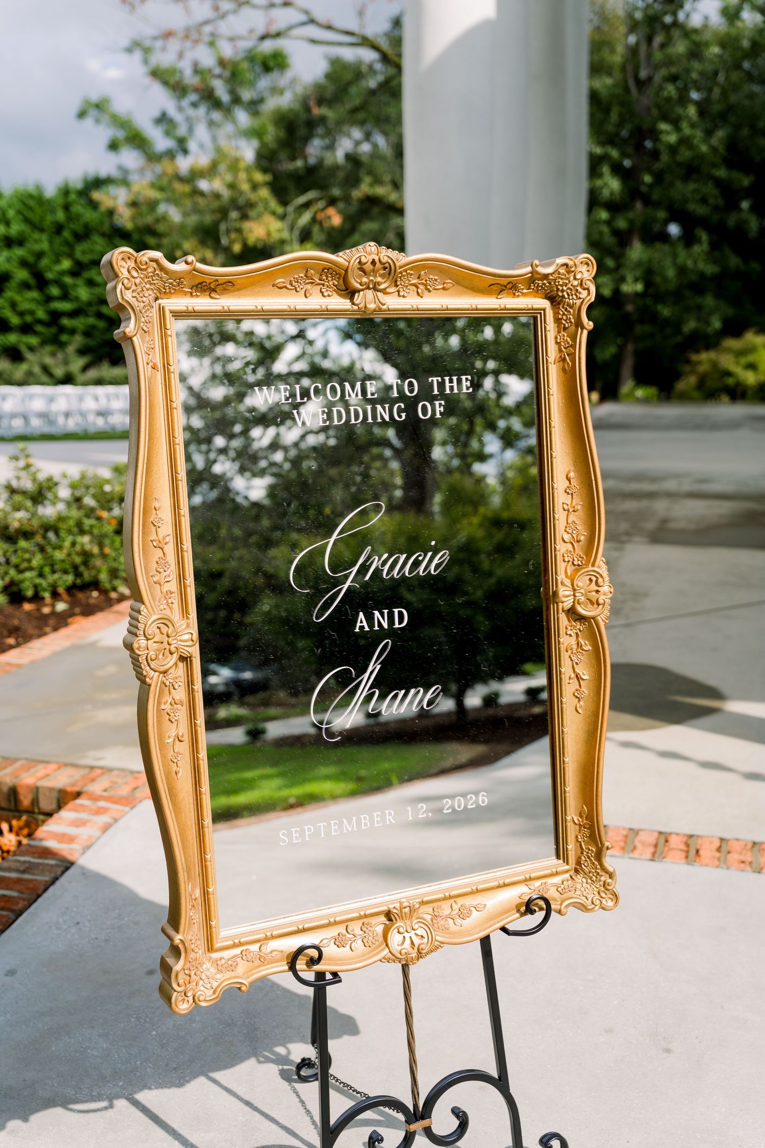 Elegant gold ornate framed mirror wedding welcome sign for Gracie and Shane, September 2020, displayed on black easel.