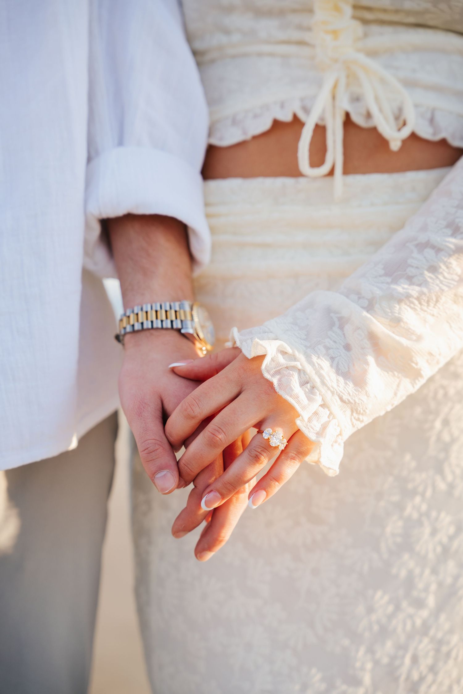 Close-up series of elegant hands wearing a silver watch against white lace fabric in soft natural lighting.