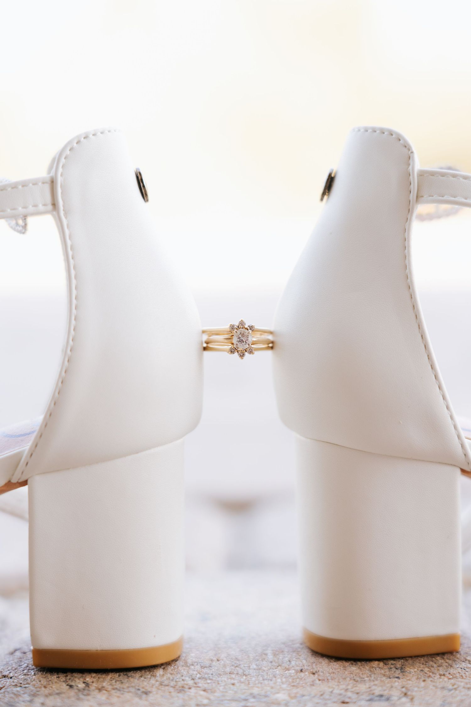 White wedding shoes arranged in a row showing different angles and details.