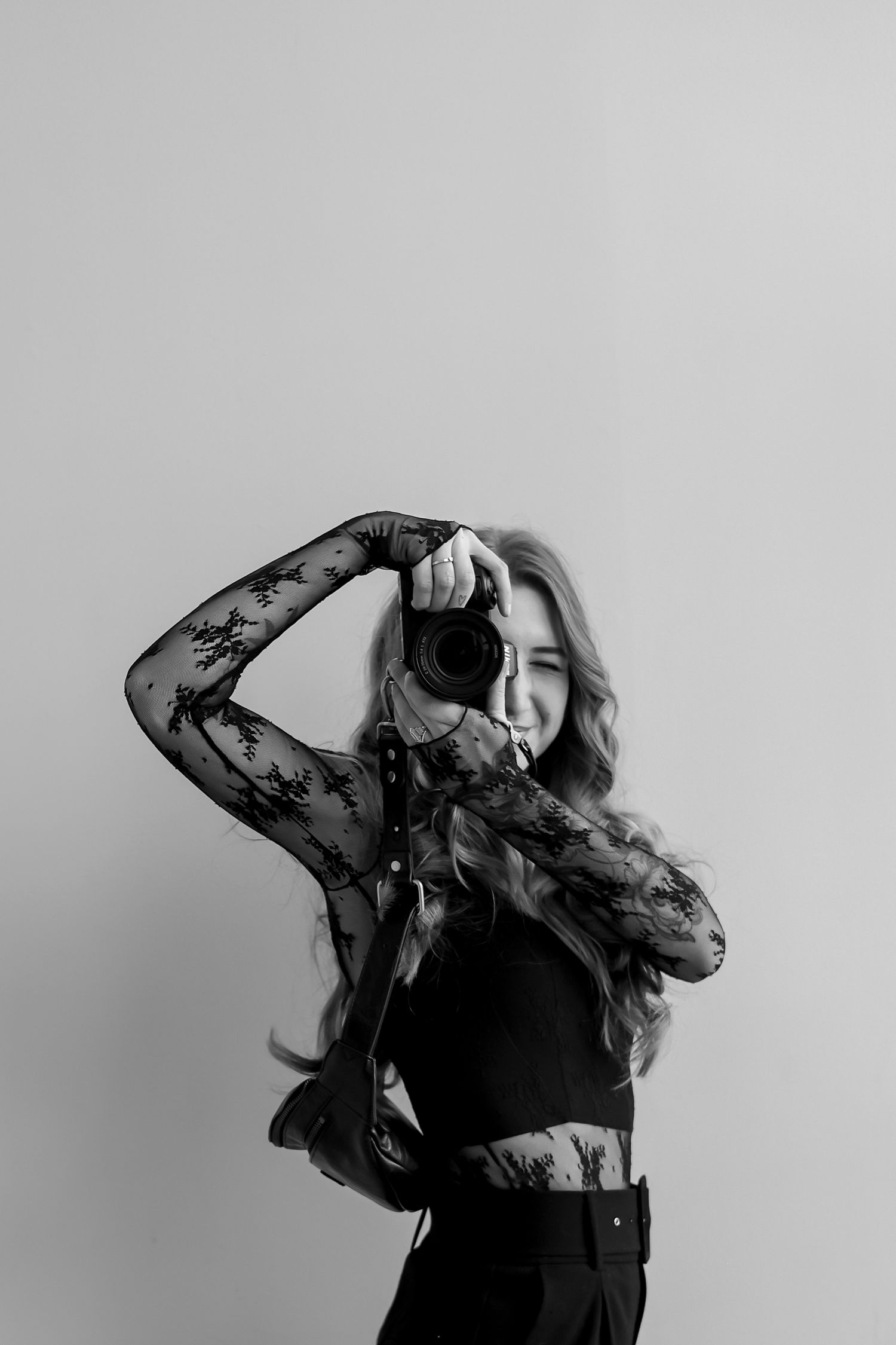 A black and white photo series shows a figure in dark clothing moving expressively against a light background.