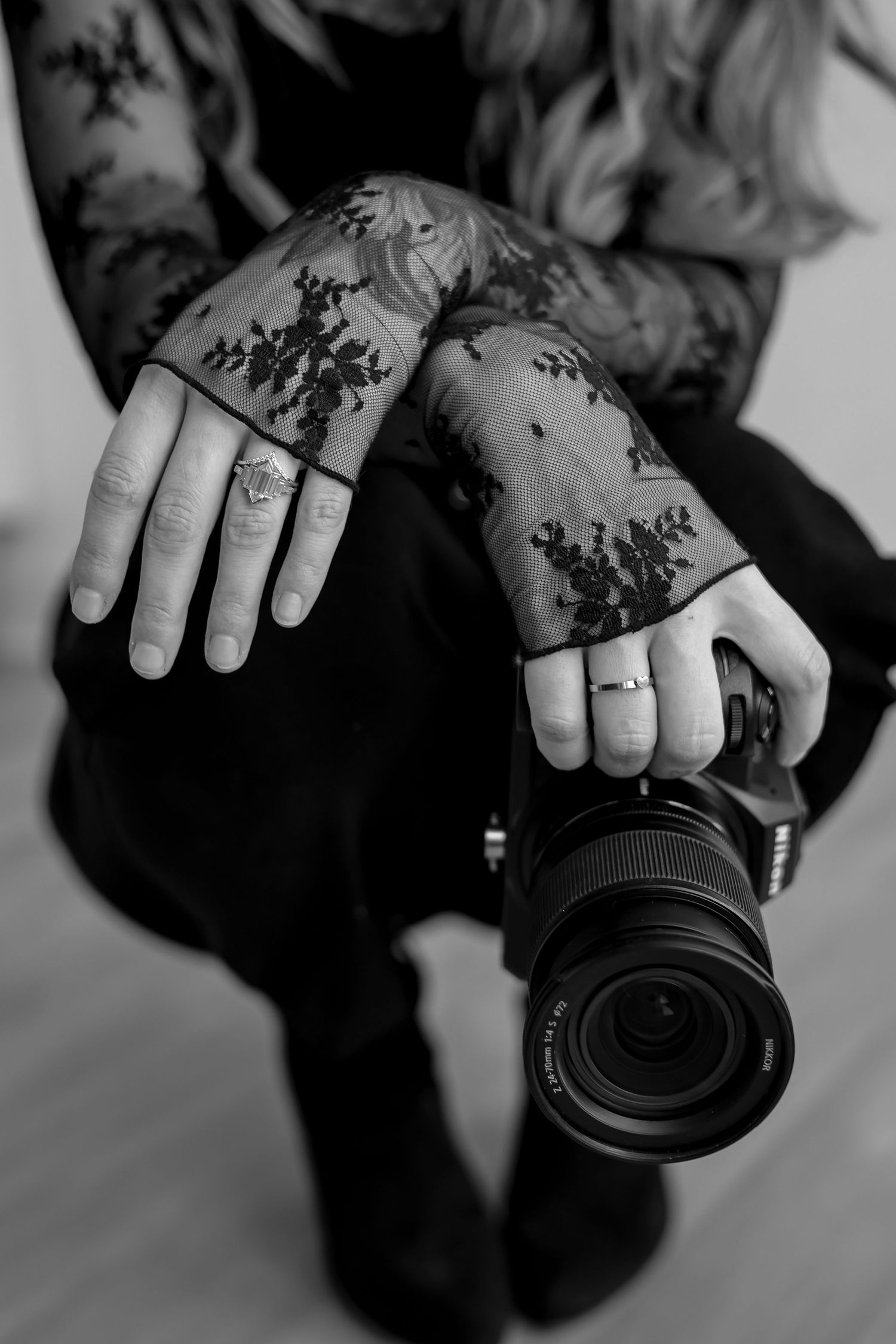 A series of black and white photos showing hands holding and adjusting camera lenses from different angles.