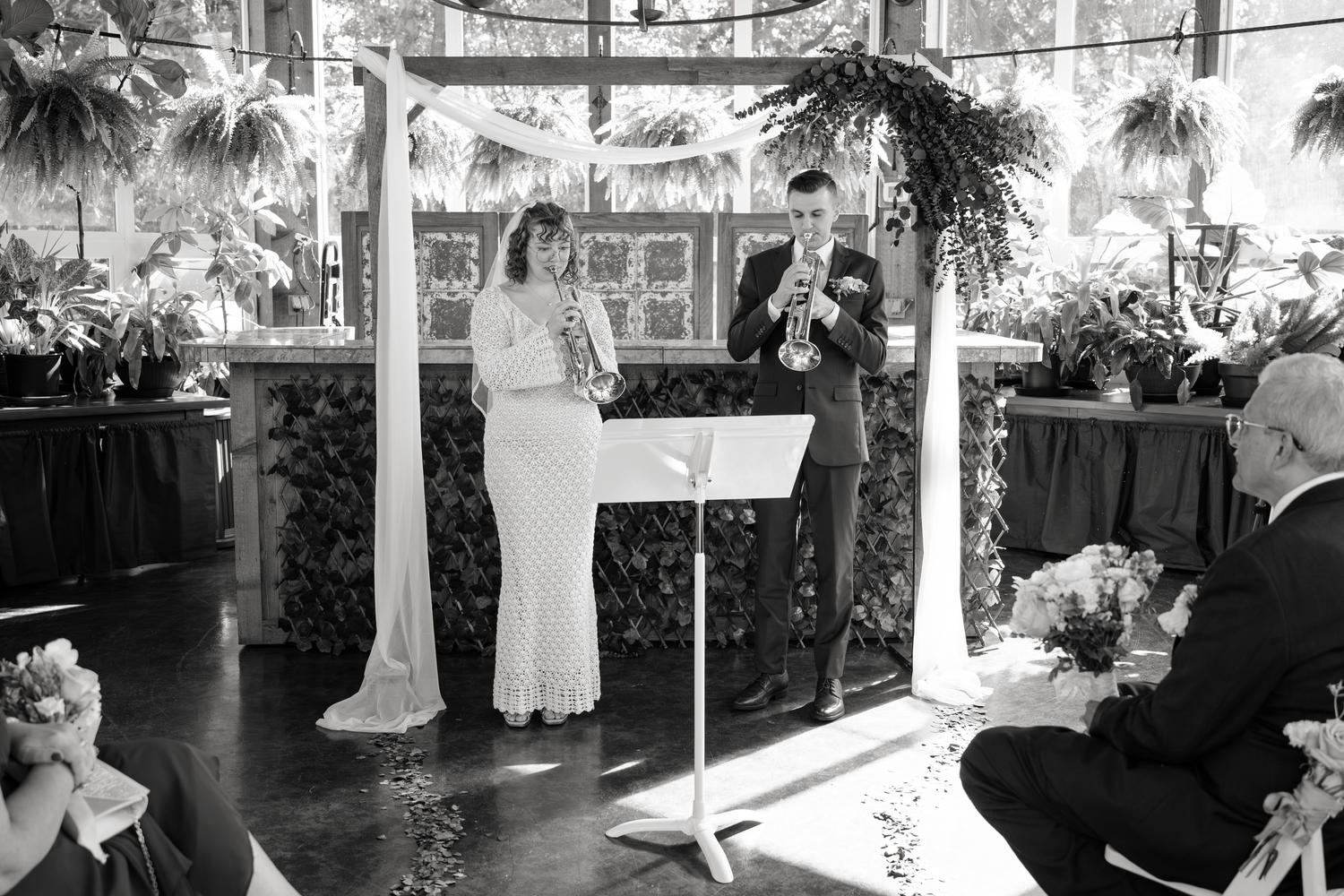 A collection of black and white wedding photographs showing couples dancing and celebrating at a reception.