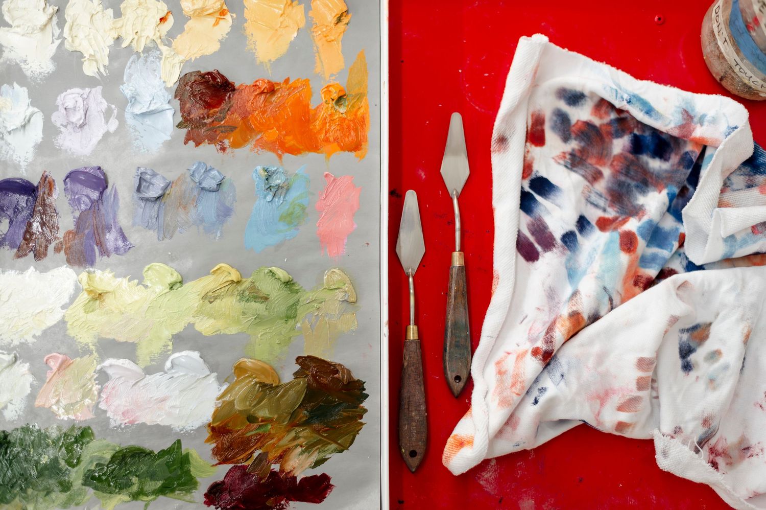 Abstract art collection featuring vibrant red, white, and multicolored paintings with expressive brushstrokes and fluid forms.
