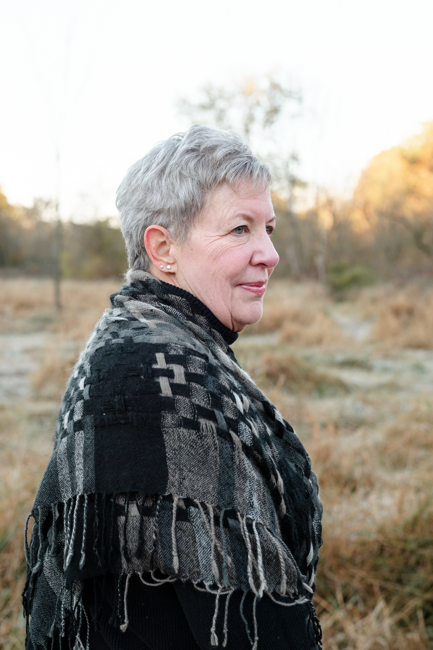 A series of profile shots showing someone wearing a black and gray knitted scarf in a natural outdoor setting at sunset.