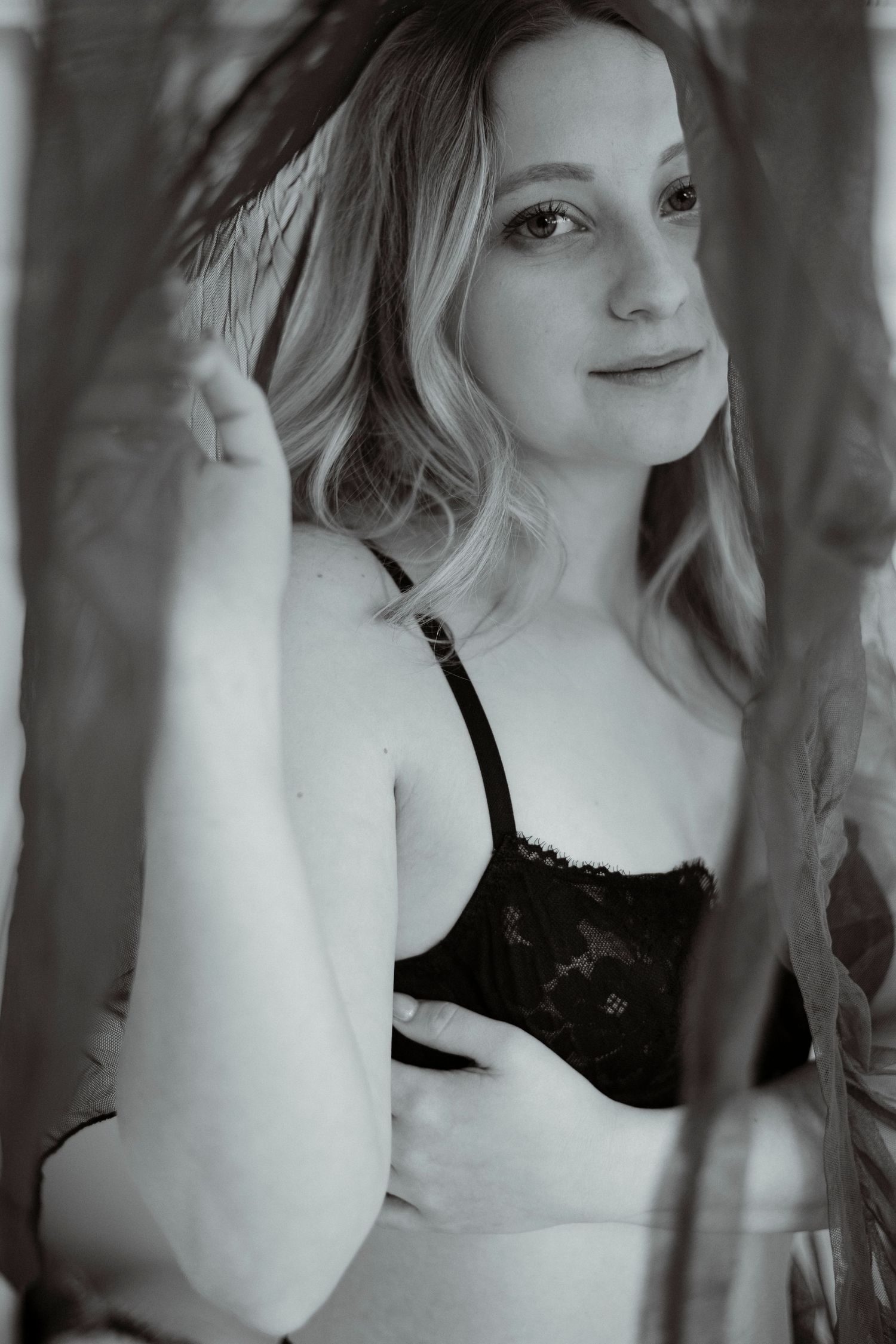 Black and white portrait series showing artistic angles and poses in moody lighting.