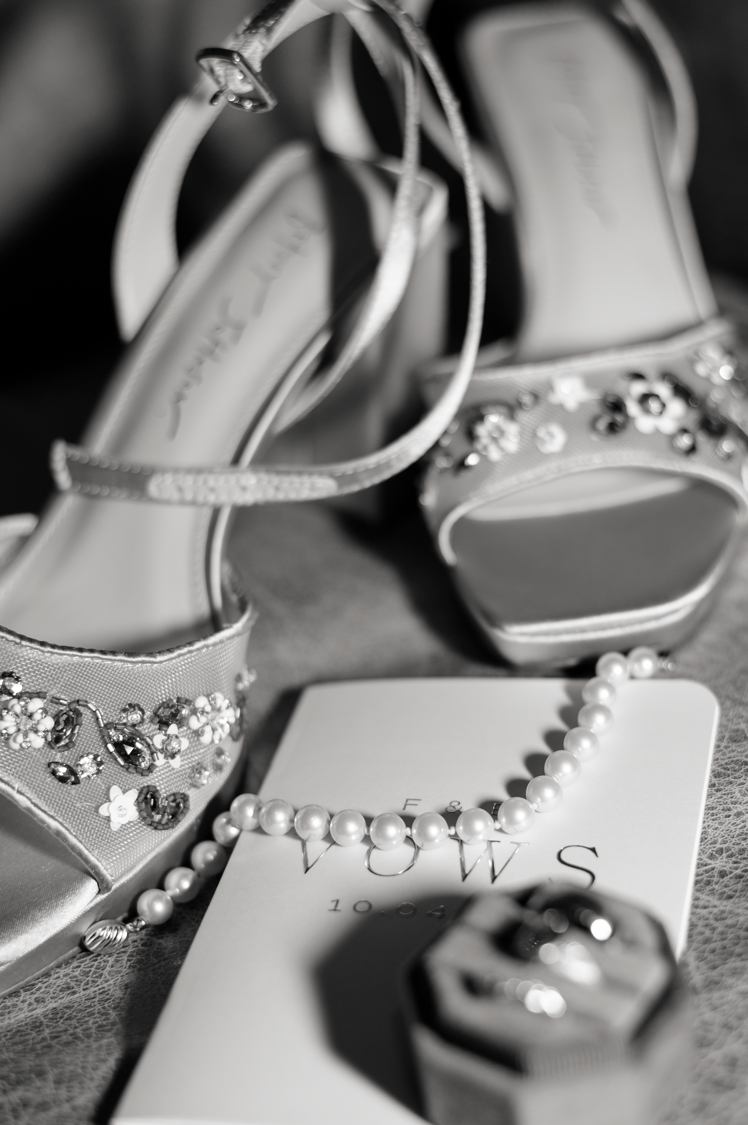 Close-up series of elegant bridal shoes with crystal embellishments and vows text in black and white photography.