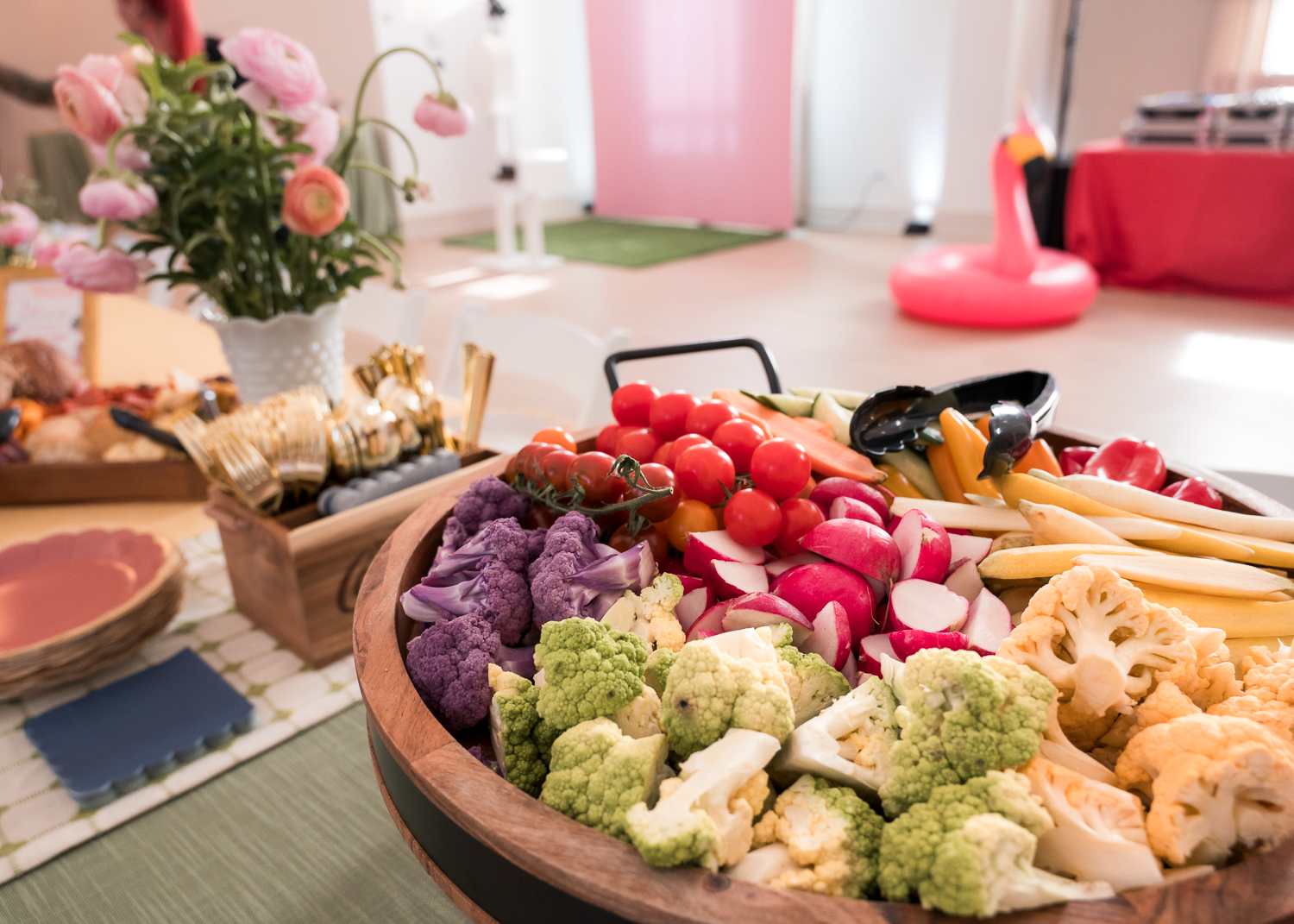 A platter of assorted fresh vegetables including broccoli, cauliflower, and colorful bell peppers arranged for serving.