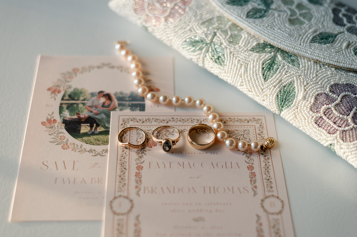 Wedding invitation with lace details and pearl necklace arranged artistically.