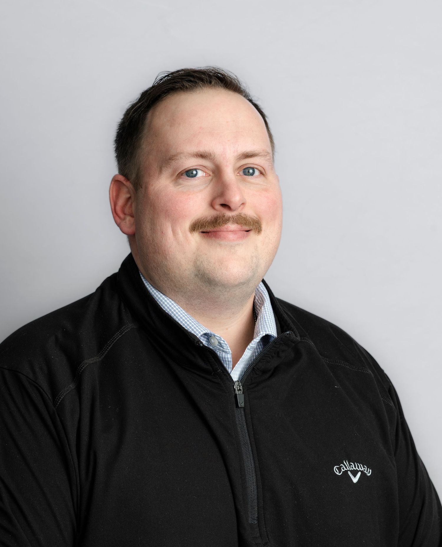 Professional headshot series showing different angles and expressions in black and white against a light background.