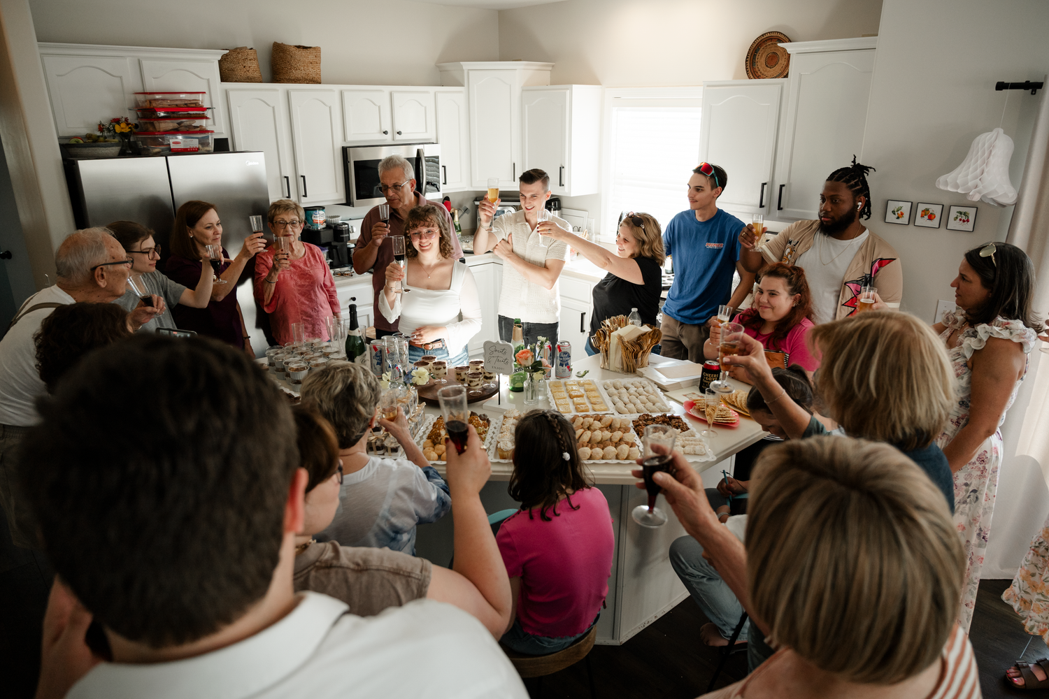 A crowded cooking class with students gathered around kitchen workstations learning culinary techniques.