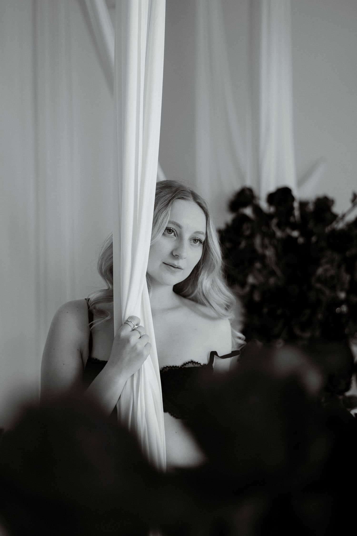Artistic black and white photo series showing ethereal silhouettes behind sheer white curtains in moody lighting.