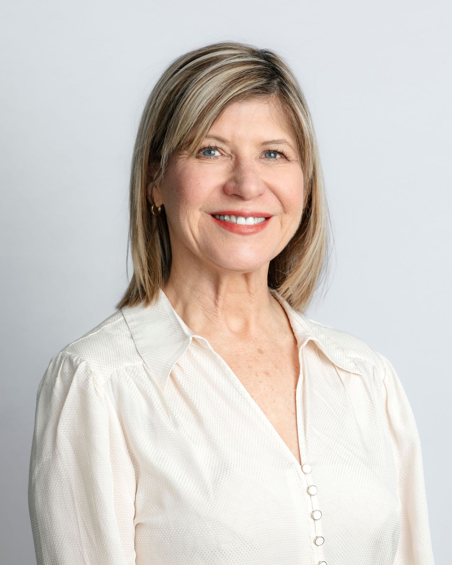 Professional headshots of a person in a white button-up shirt against a light gray background.