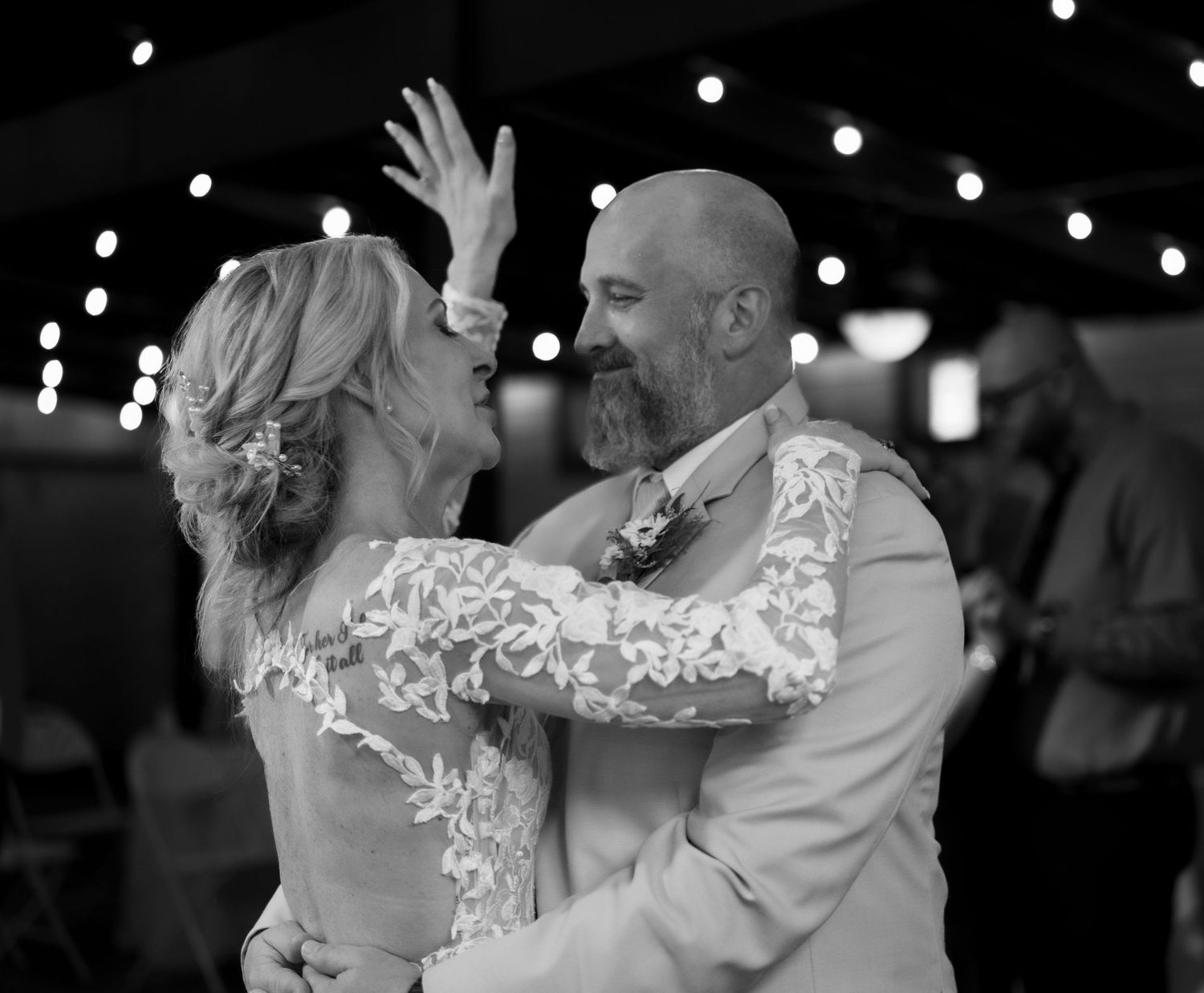 Black and white wedding dance photos showing romantic moments under twinkling lights.