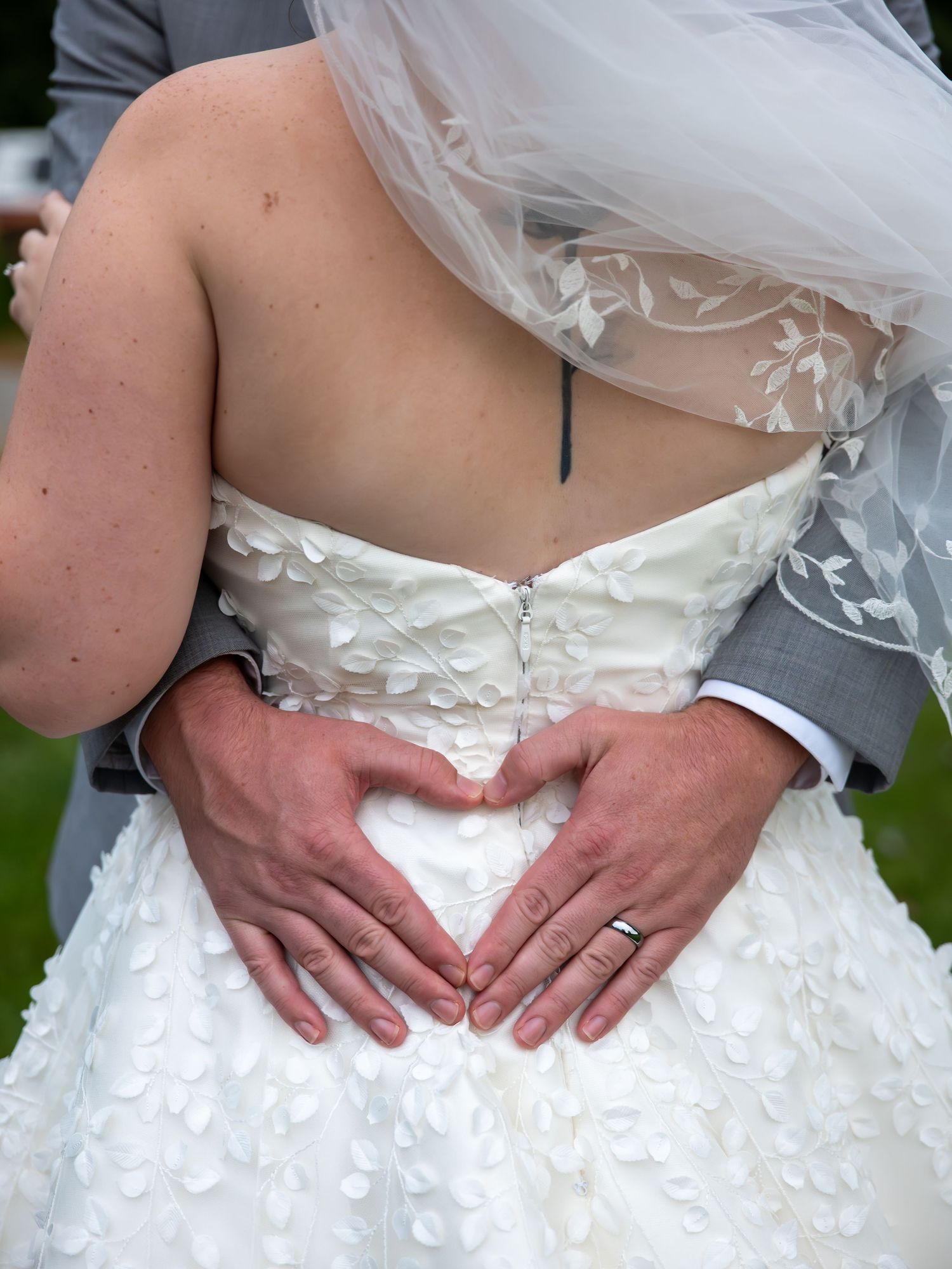 Close-up detail shots of a white wedding dress with delicate floral appliques.