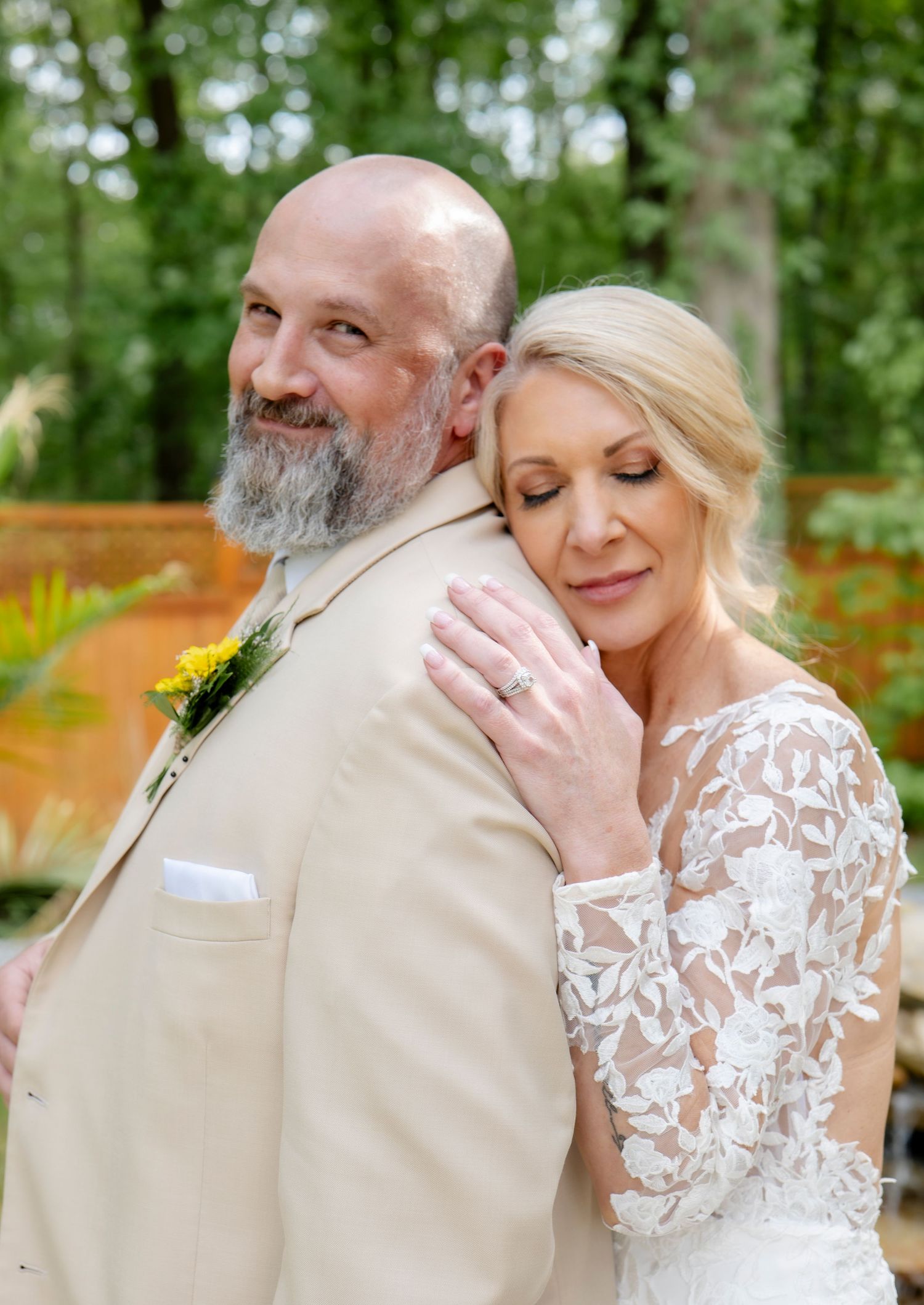 Intimate wedding portraits showing tender moments in outdoor garden setting.