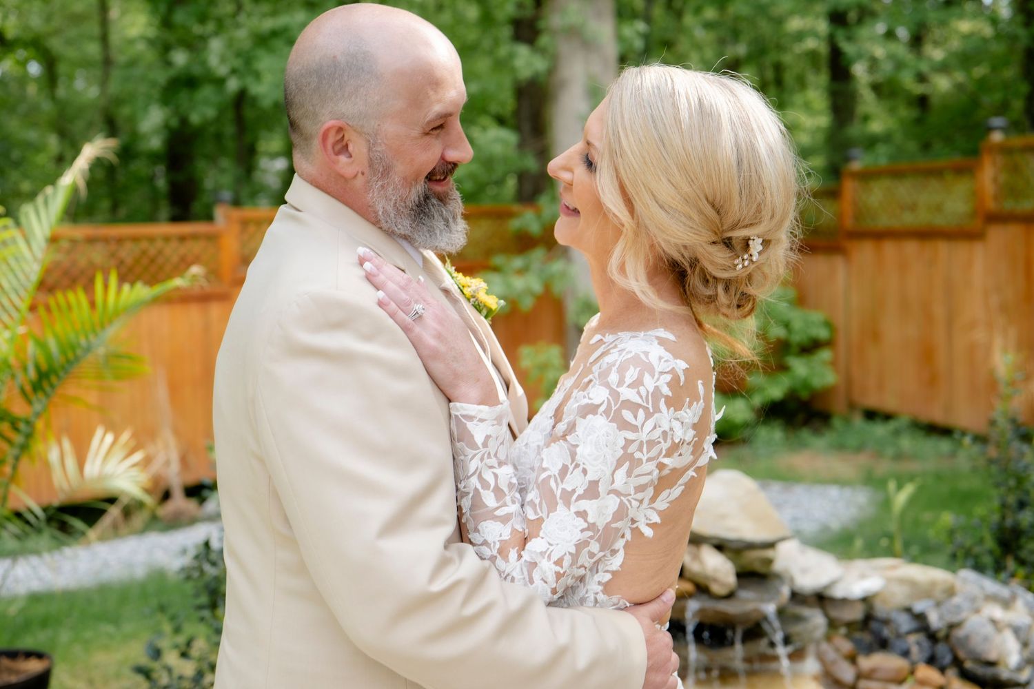 Candid wedding portraits captured in lush garden setting.