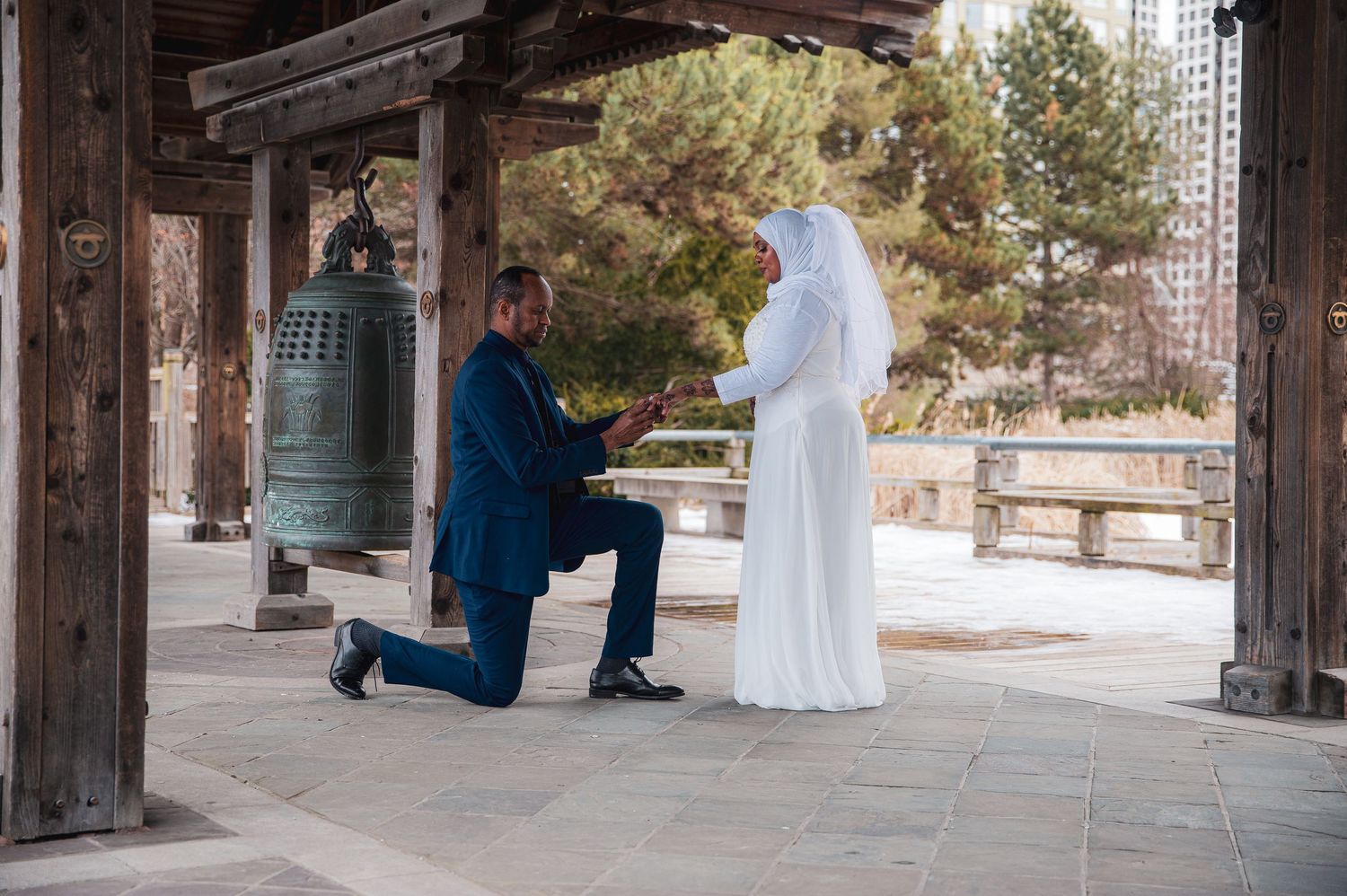 A romantic proposal moment takes place at a traditional Japanese temple with a large bell in the background.