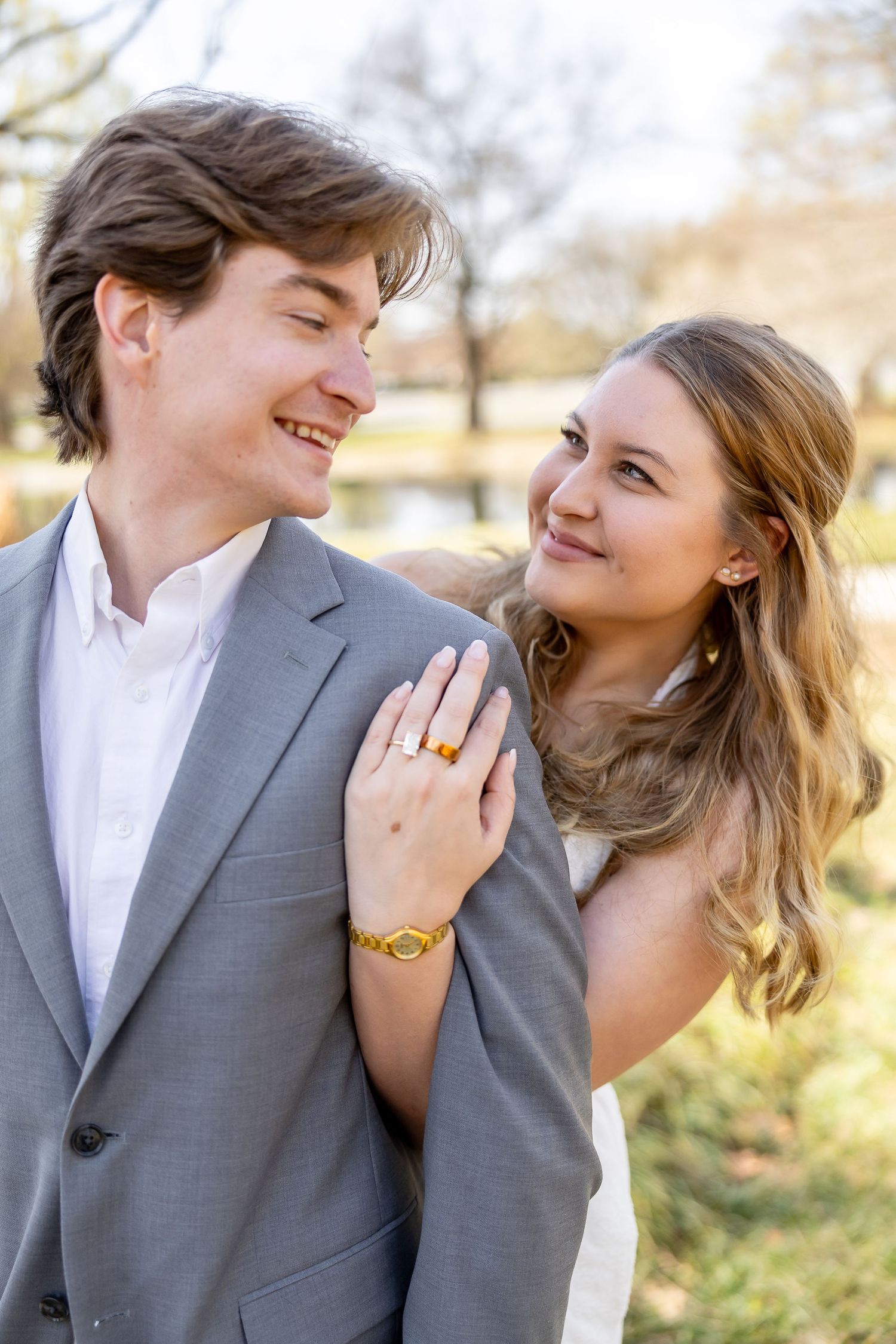 A couple shares intimate romantic moments outdoors while dressed in formal attire during a photo session.