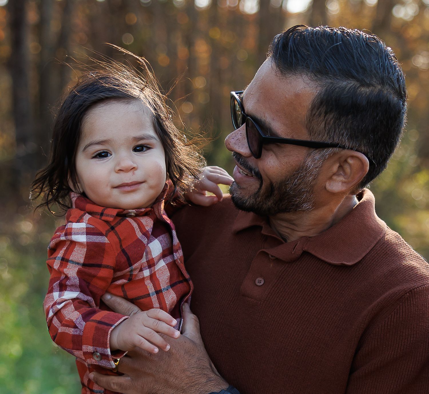 A series of tender moments captured between a parent and child in a red plaid shirt against an autumn forest backdrop.