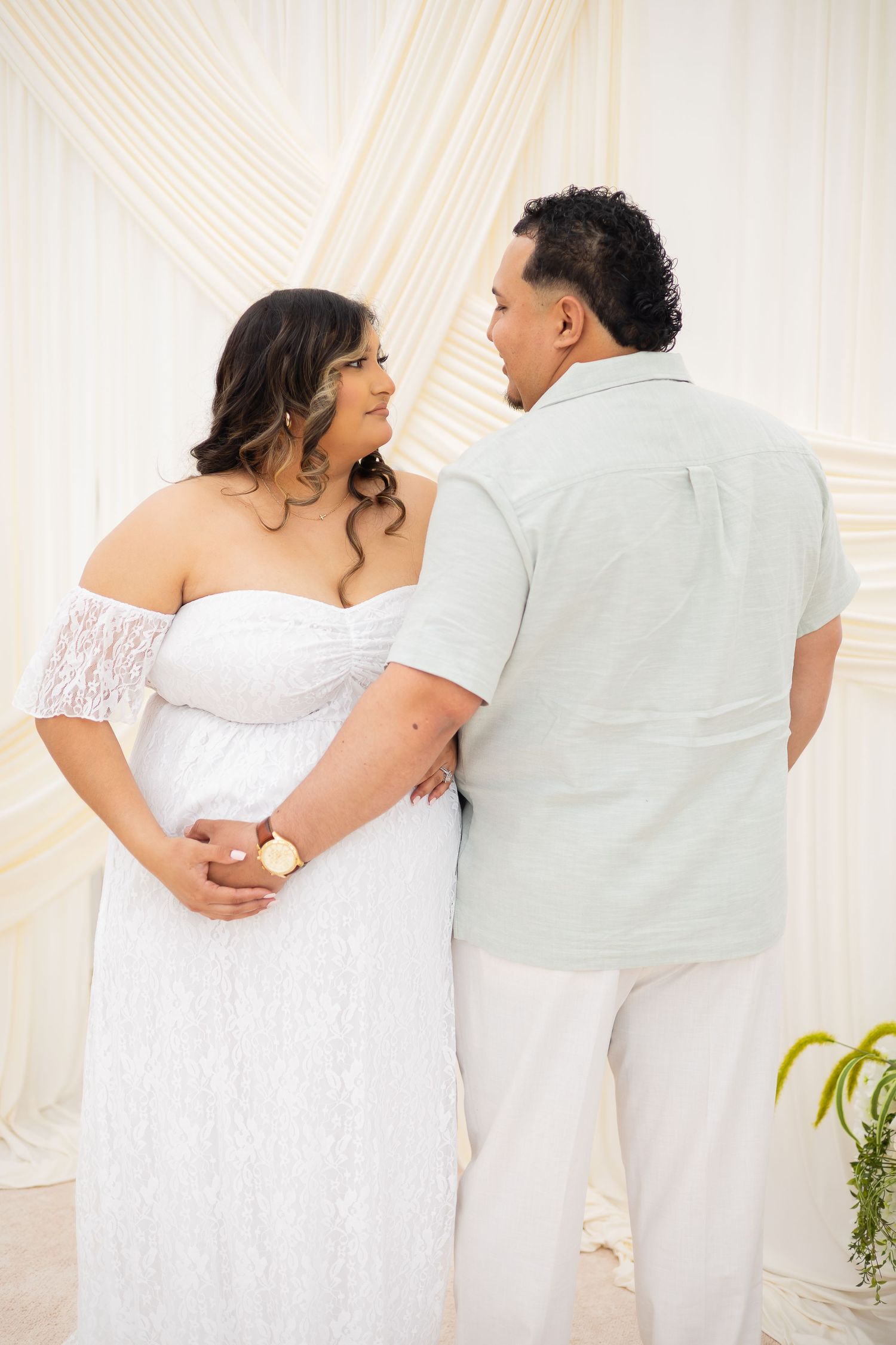 Romantic wedding couple in white attire embracing while walking together in a series of connected photos.