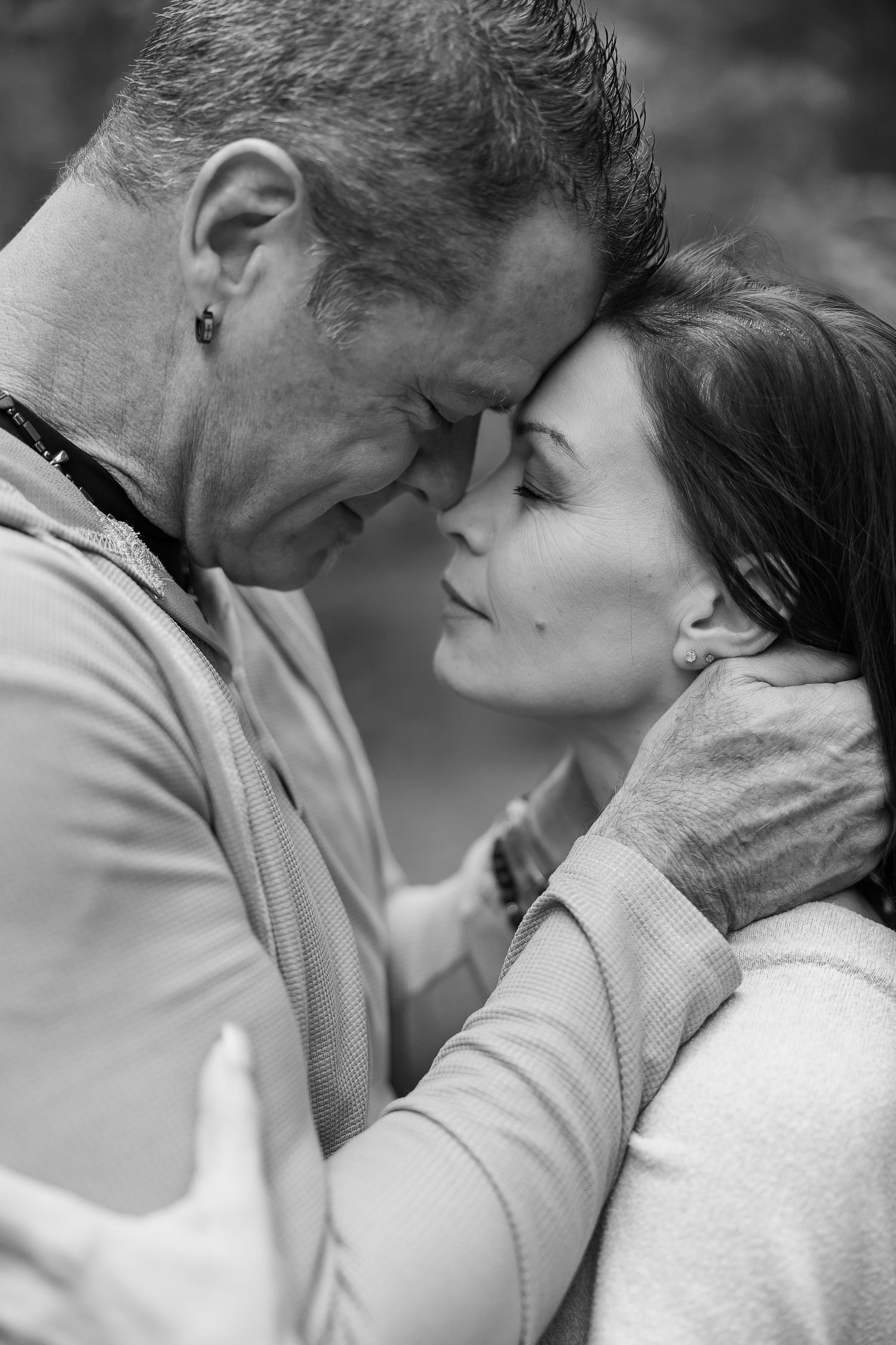 A romantic black and white photo sequence showing an intimate moment between a couple in soft lighting.