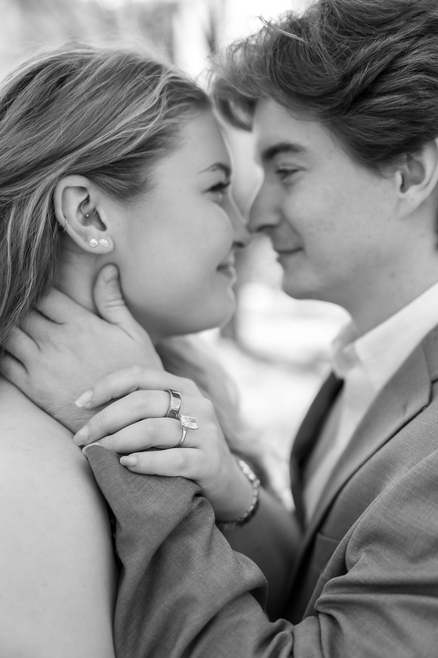 A romantic black and white photo sequence showing a couple in an intimate close-up kiss.
