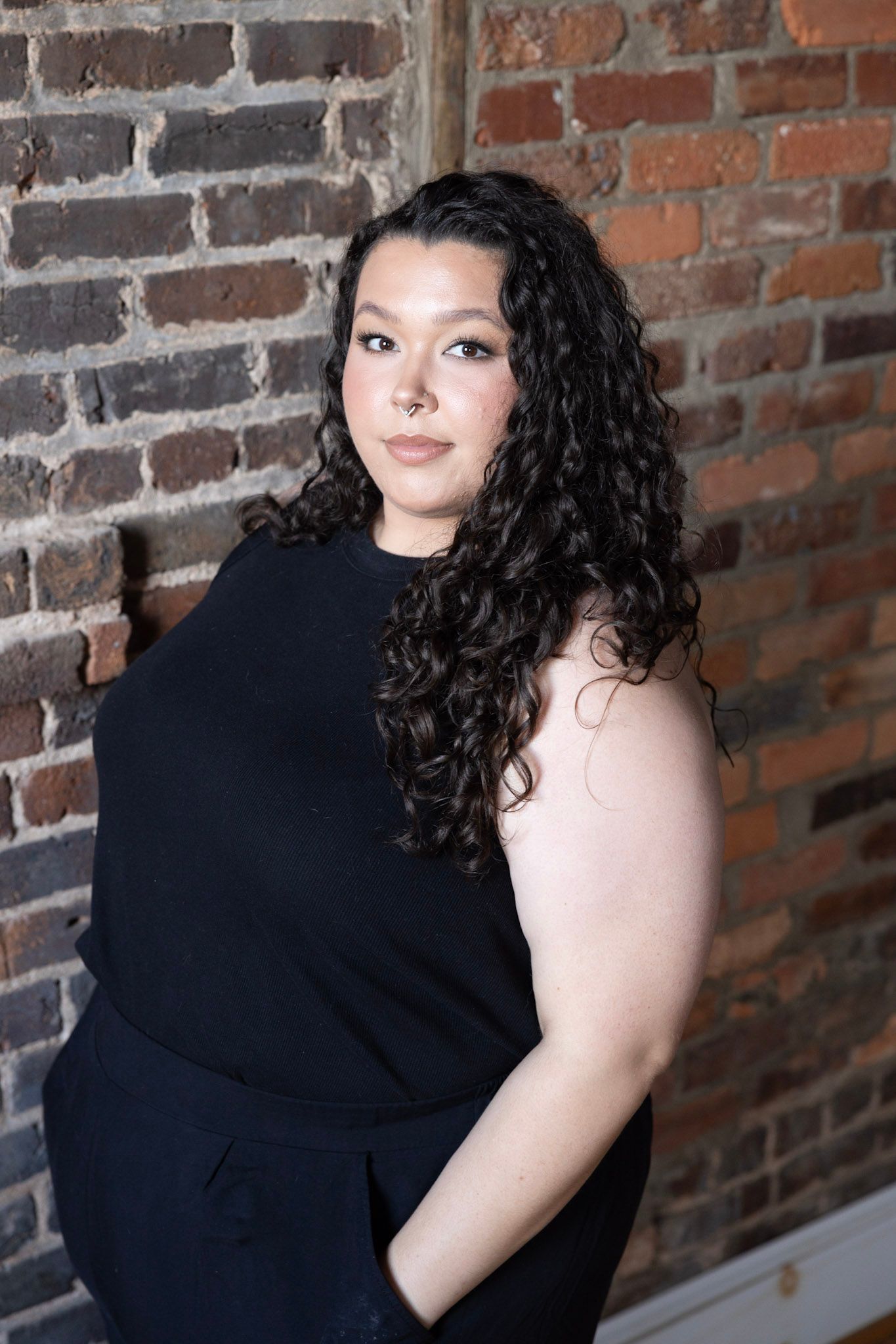 Artistic portrait series against textured brick wall showing dramatic poses.