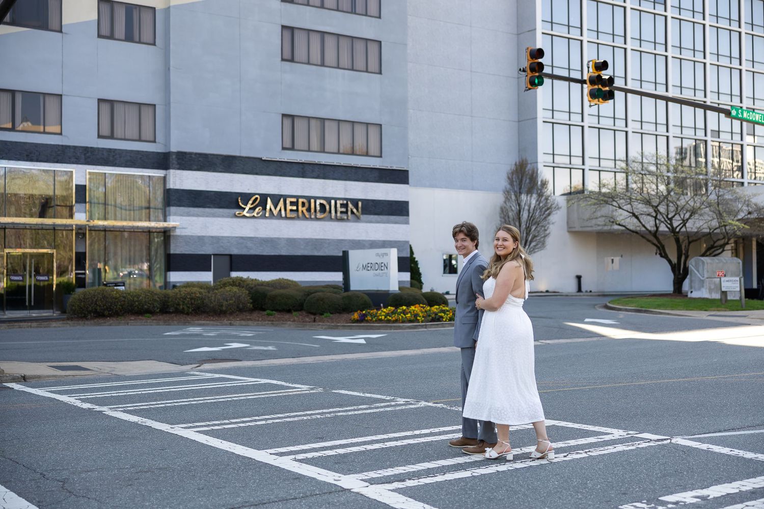 A sequence of parking lot photos showing a person in white dress posing near office buildings and road markings.