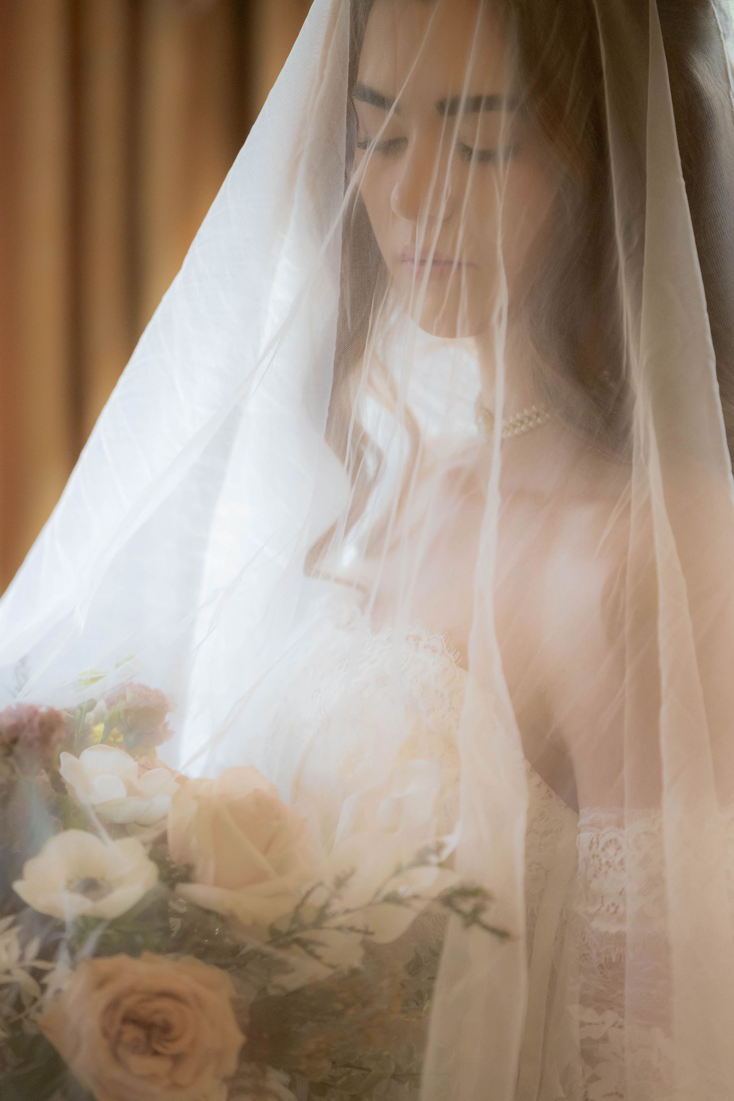 A dreamy sequence of bridal portraits showing a white veil and soft pink roses in warm lighting.