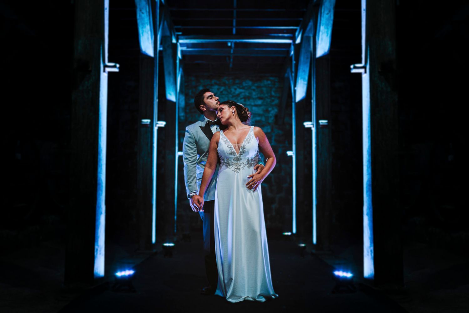 A sequence of fashion photos showing a model in an elegant white flowy dress against dramatic blue lighting and backdrops.