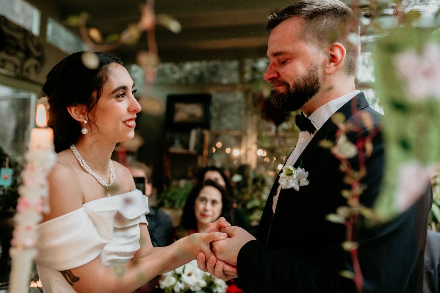 Joyful newlywed couple sharing a candid moment during their wedding ceremony while exchanging rings.