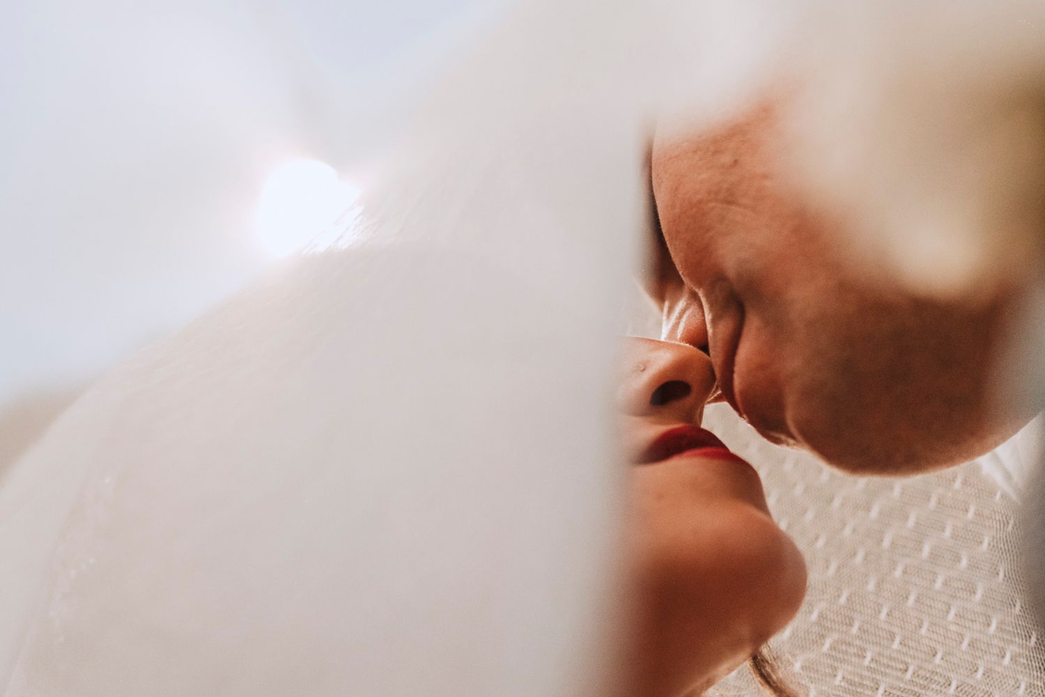 Couple sharing intimate moments during their wedding ceremony in a warm and romantic setting.