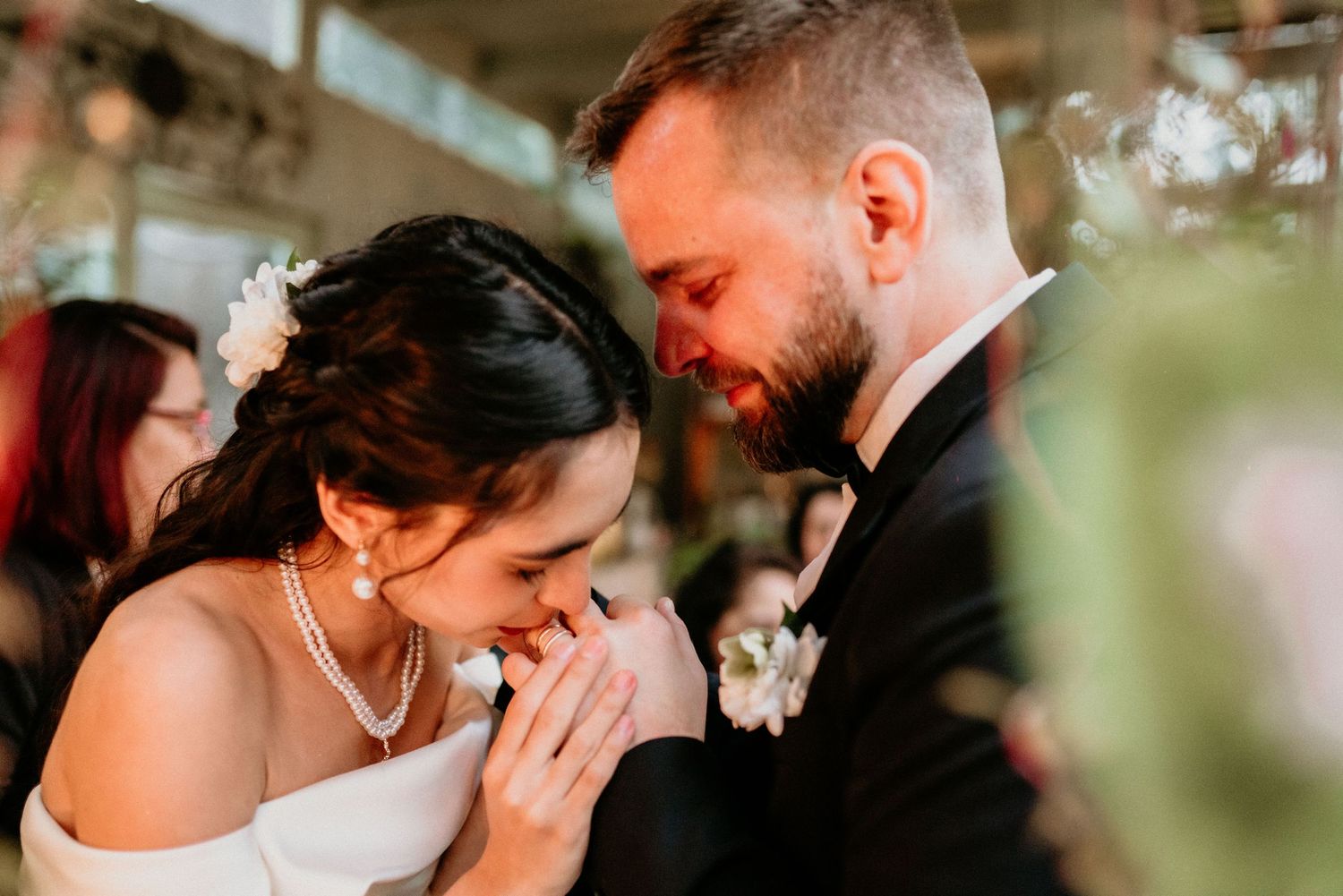 A joyful candid moment shared between a bride and groom during their wedding ceremony.