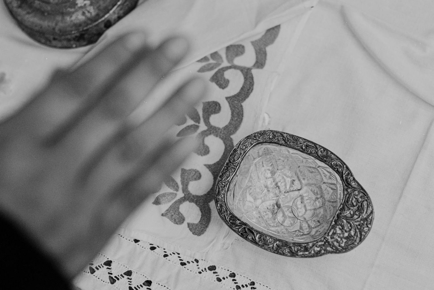 Black and white close-up photograph of intricate ornamental designs and patterns on fabric or textile.