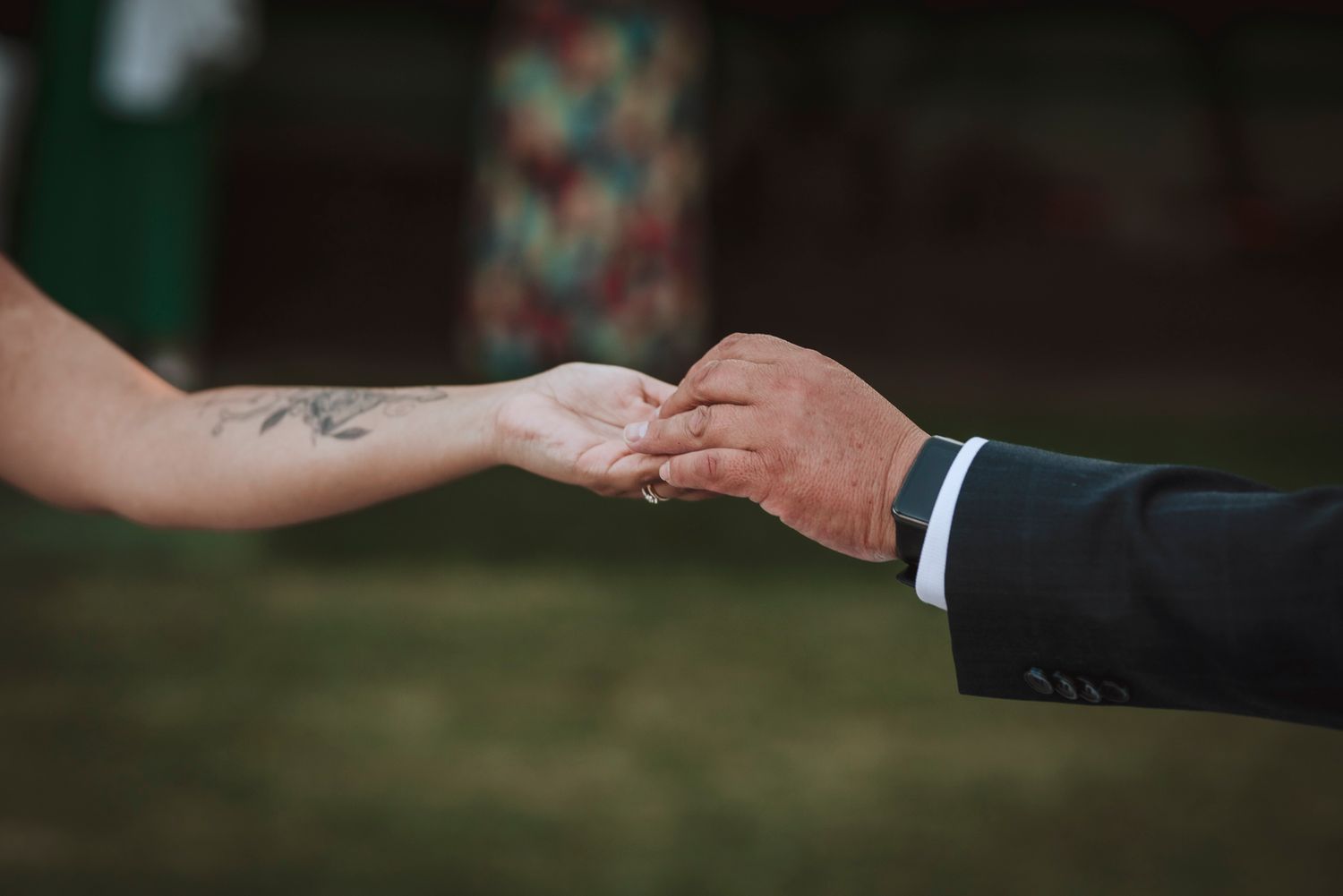 Detailed shot of wedding rings being exchanged during ceremony.