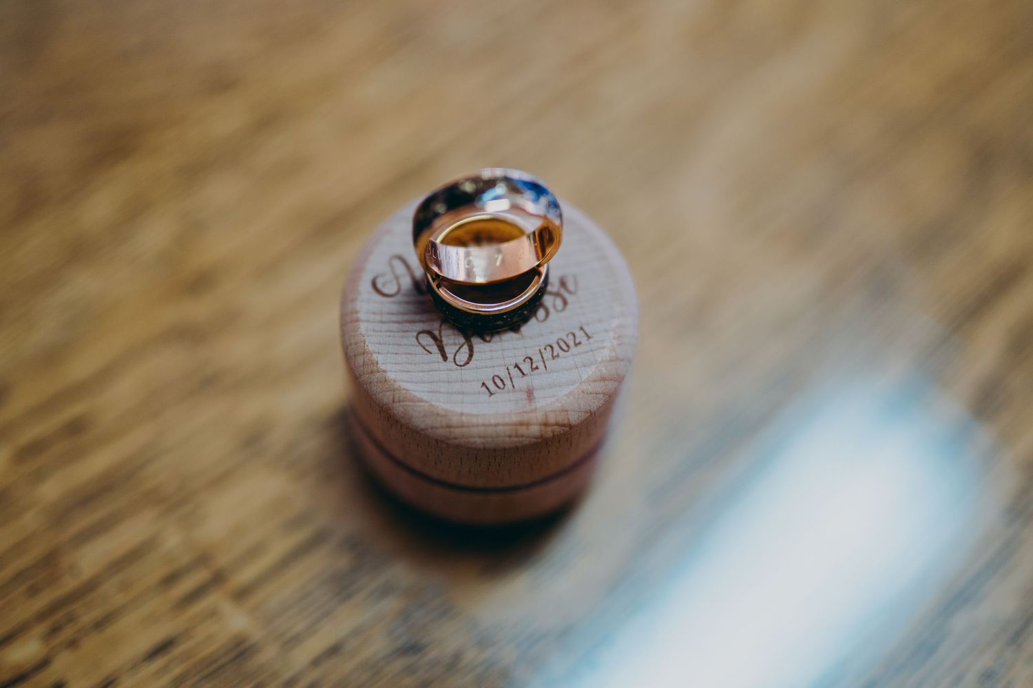 Copper penny coins arranged in a row on a wooden surface, photographed with shallow depth of field.