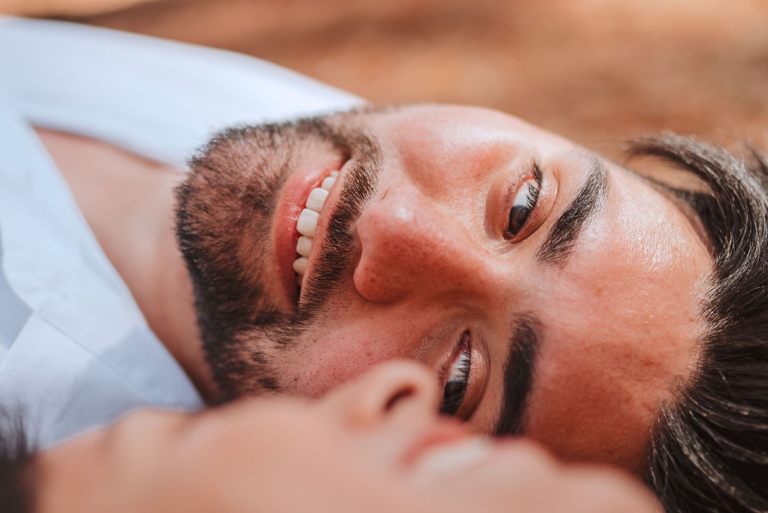 Close-up portrait shot with warm tones and soft natural lighting.
