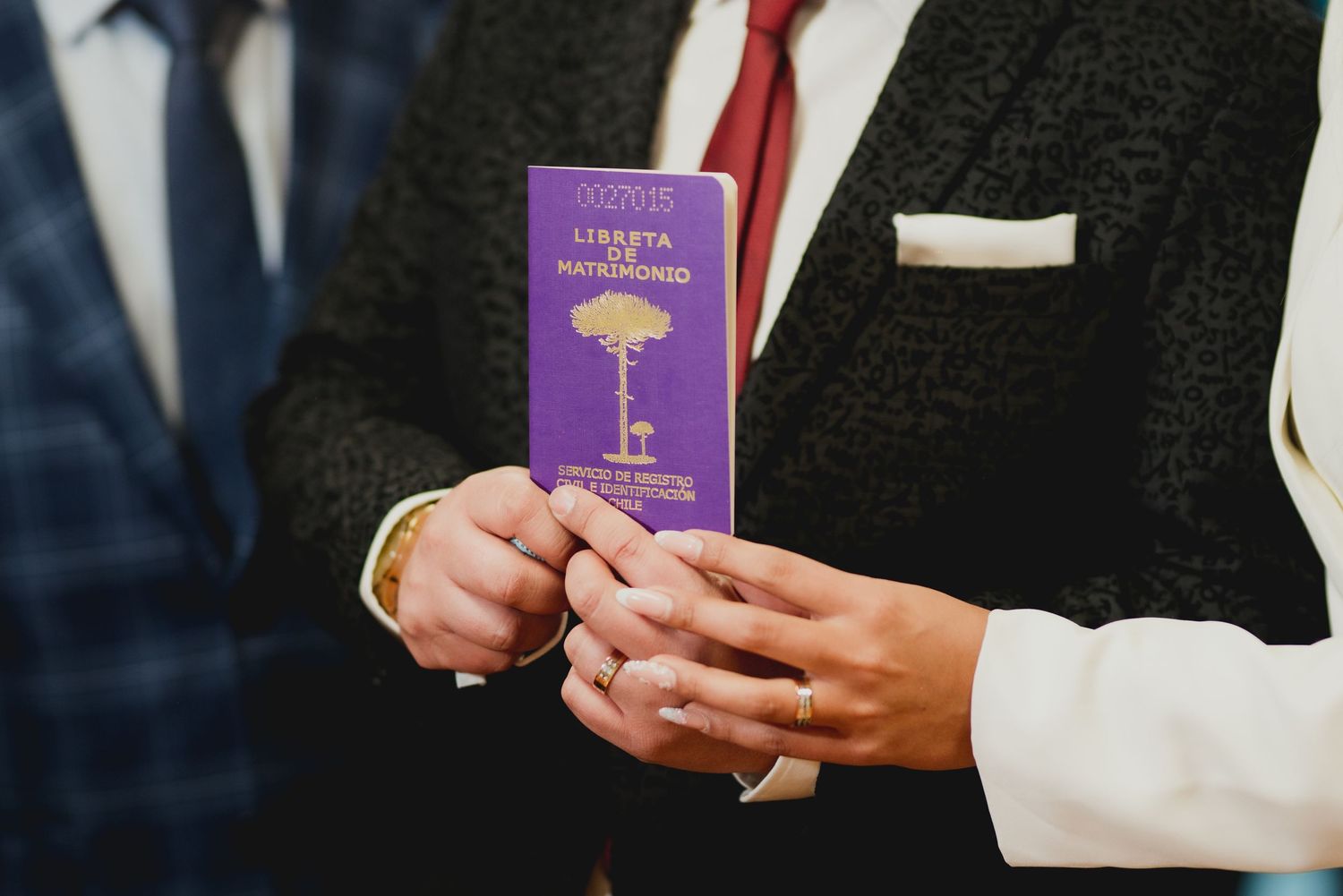 Business person in a suit holds a purple rewards membership card while demonstrating a loyalty program.