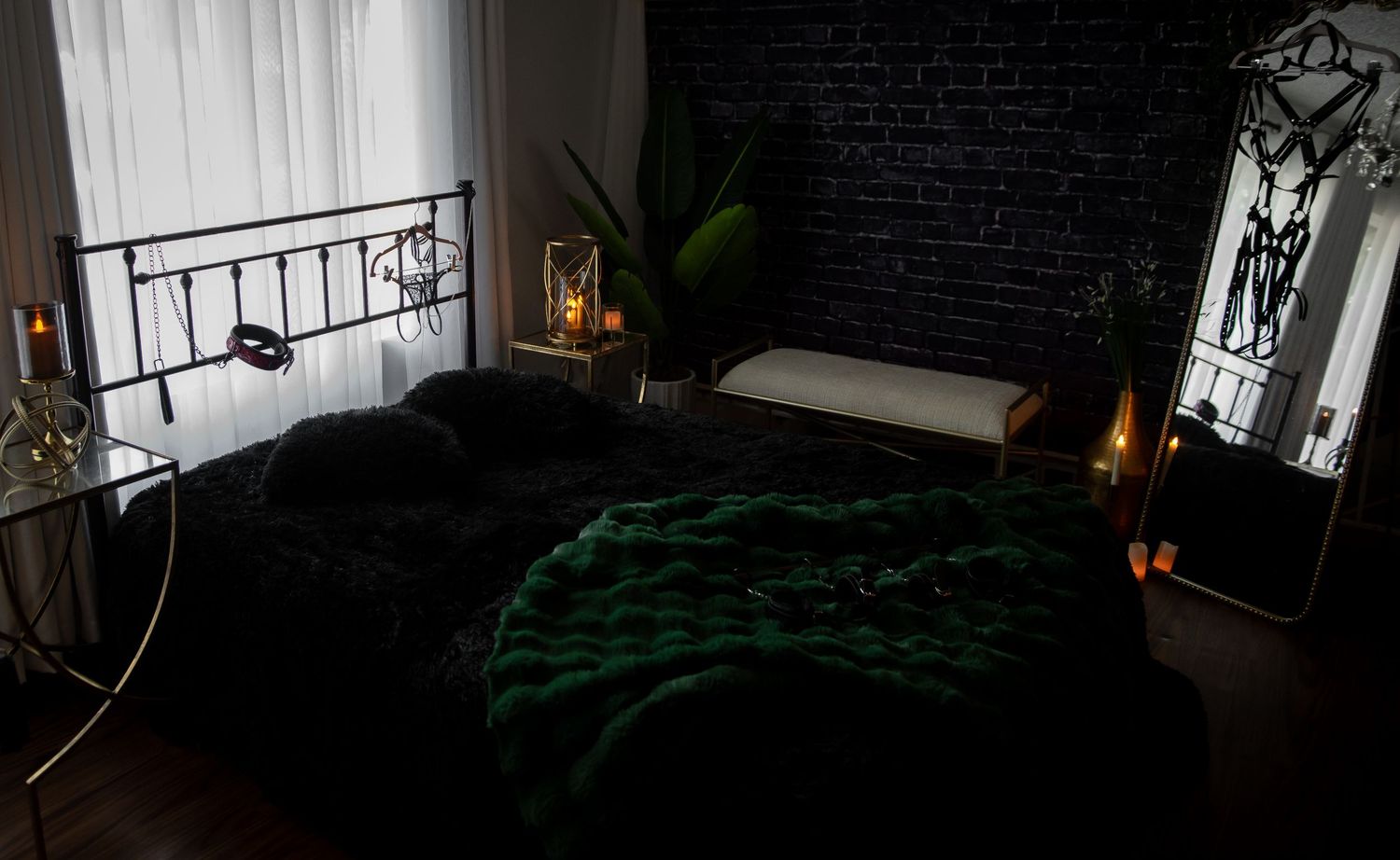 Dark and moody interior decorations featuring brick walls, candlelight, and green plants creating a mysterious dark and moody boudoir feel.