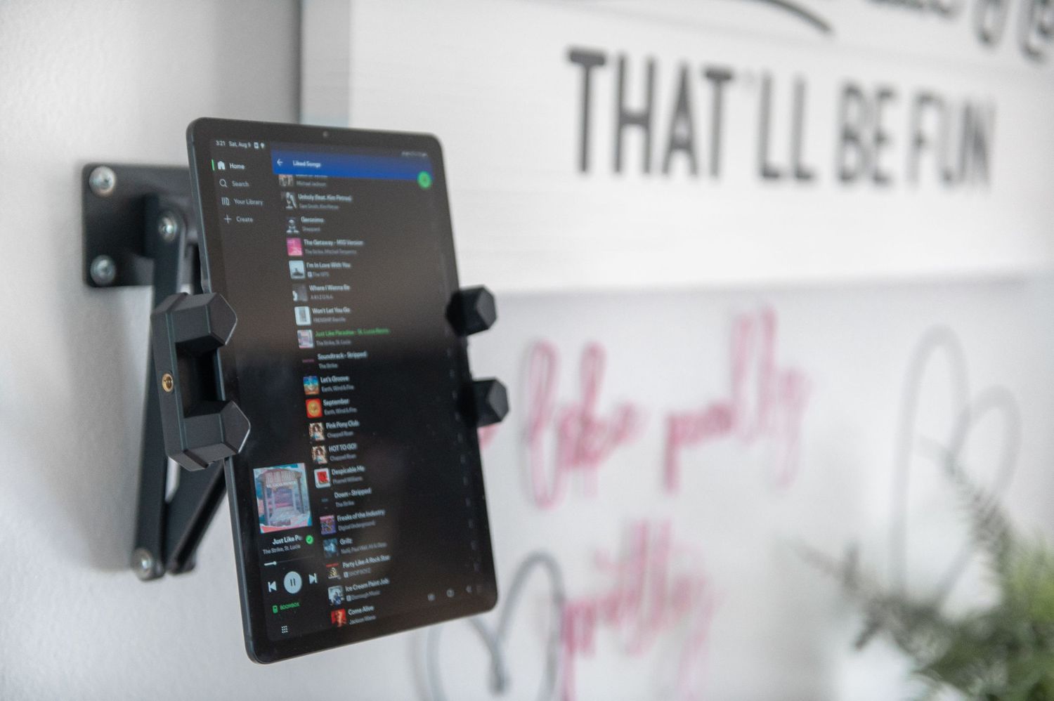 A tablet mounted to the wall in the boudoir client closet area of this Seattle studio where clients can play their preferred music.