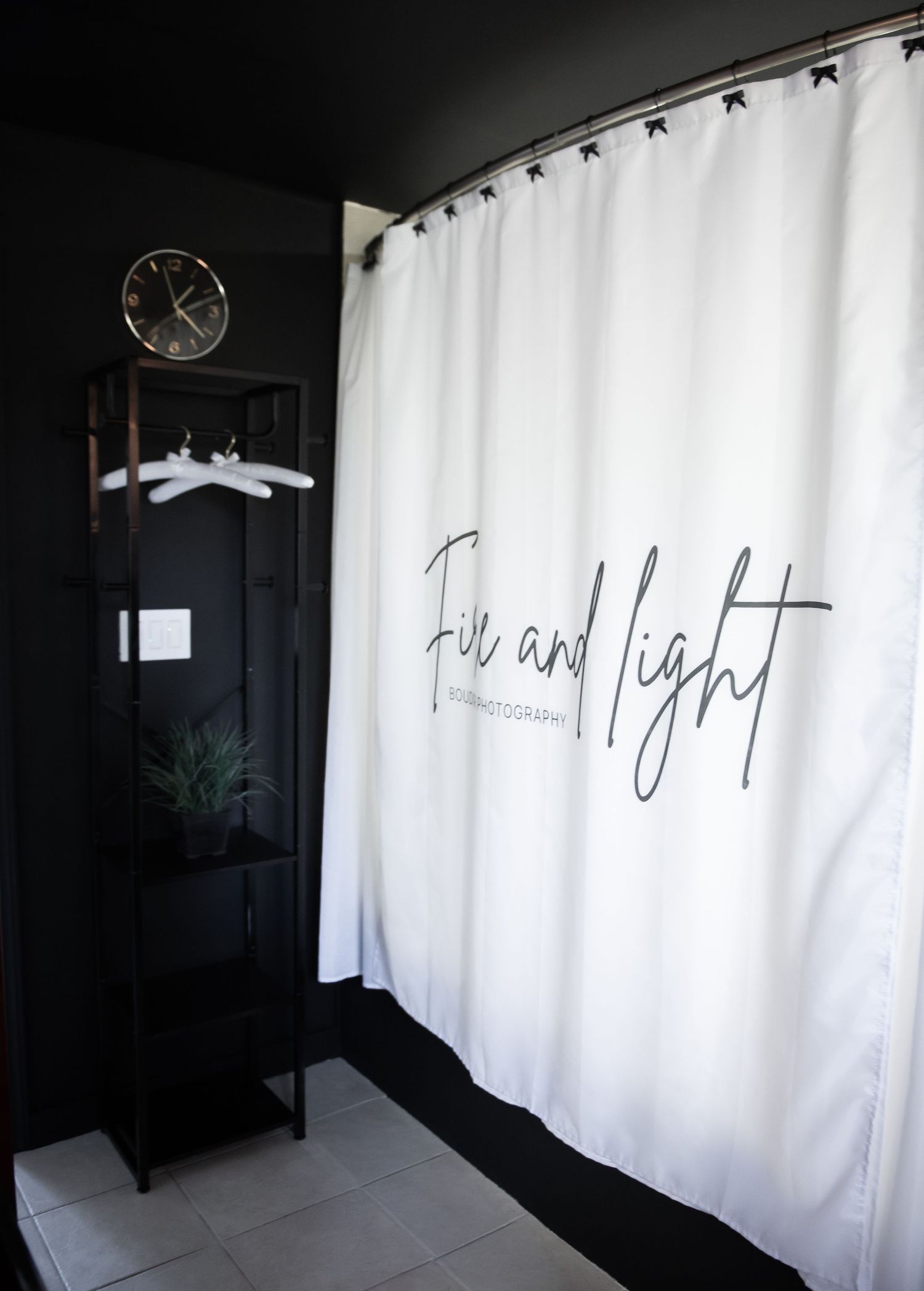 White curtains with handwritten text against dark walls create a minimalist modern interior design contrast.