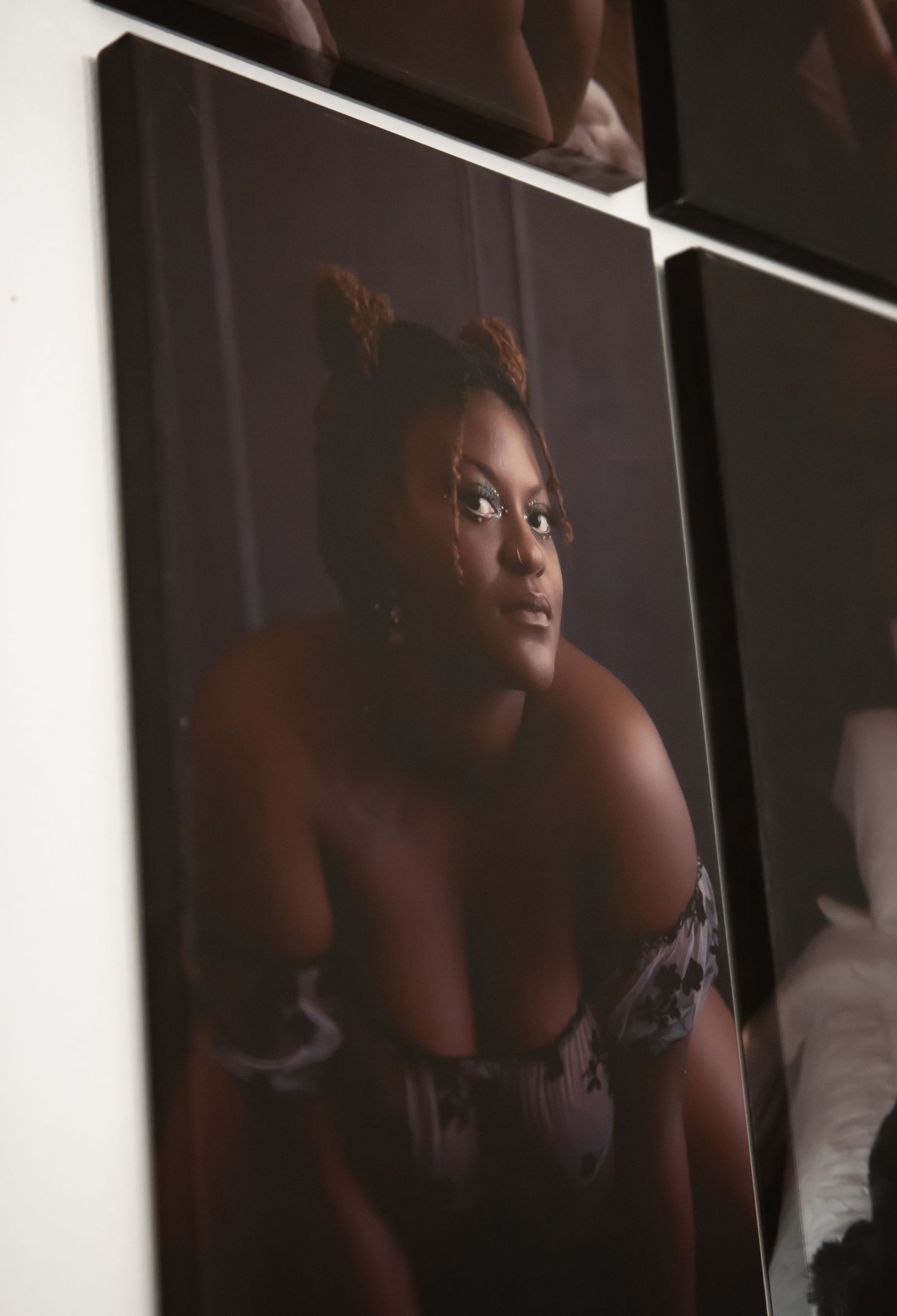 A dark and moody artistic portrait photograph showing a person in dramatic shadows and lighting.