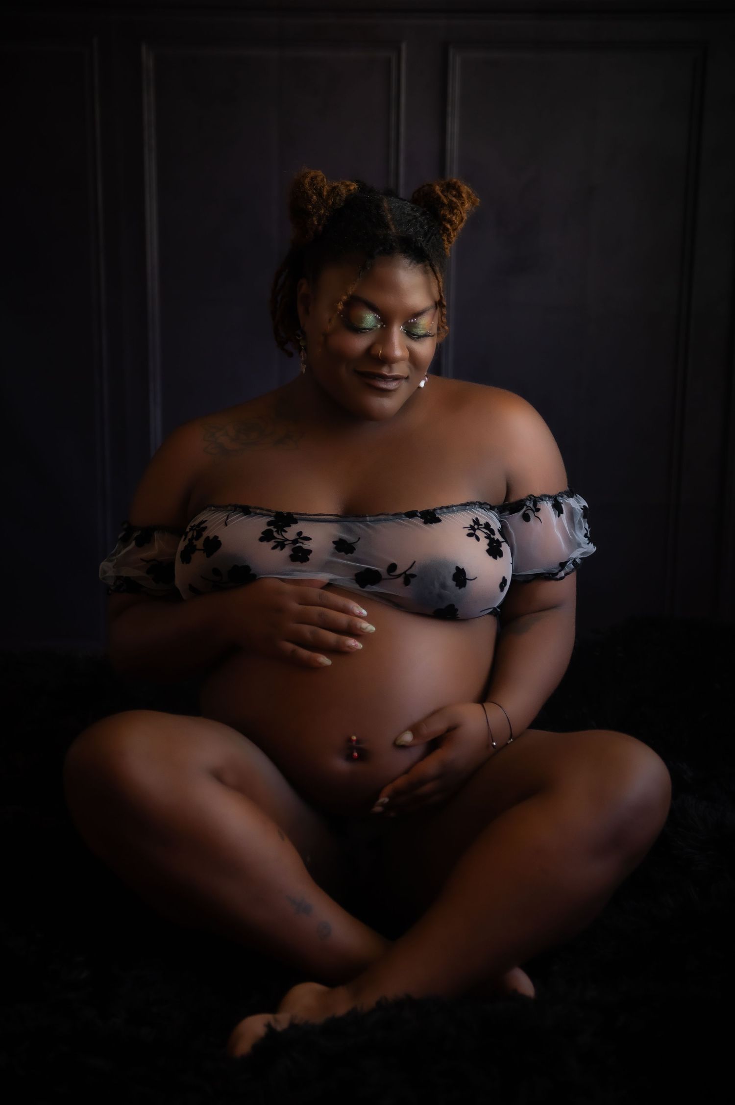 A dramatic dark photo series showing a sensual silhouette in an off-shoulder top against a black backdrop.