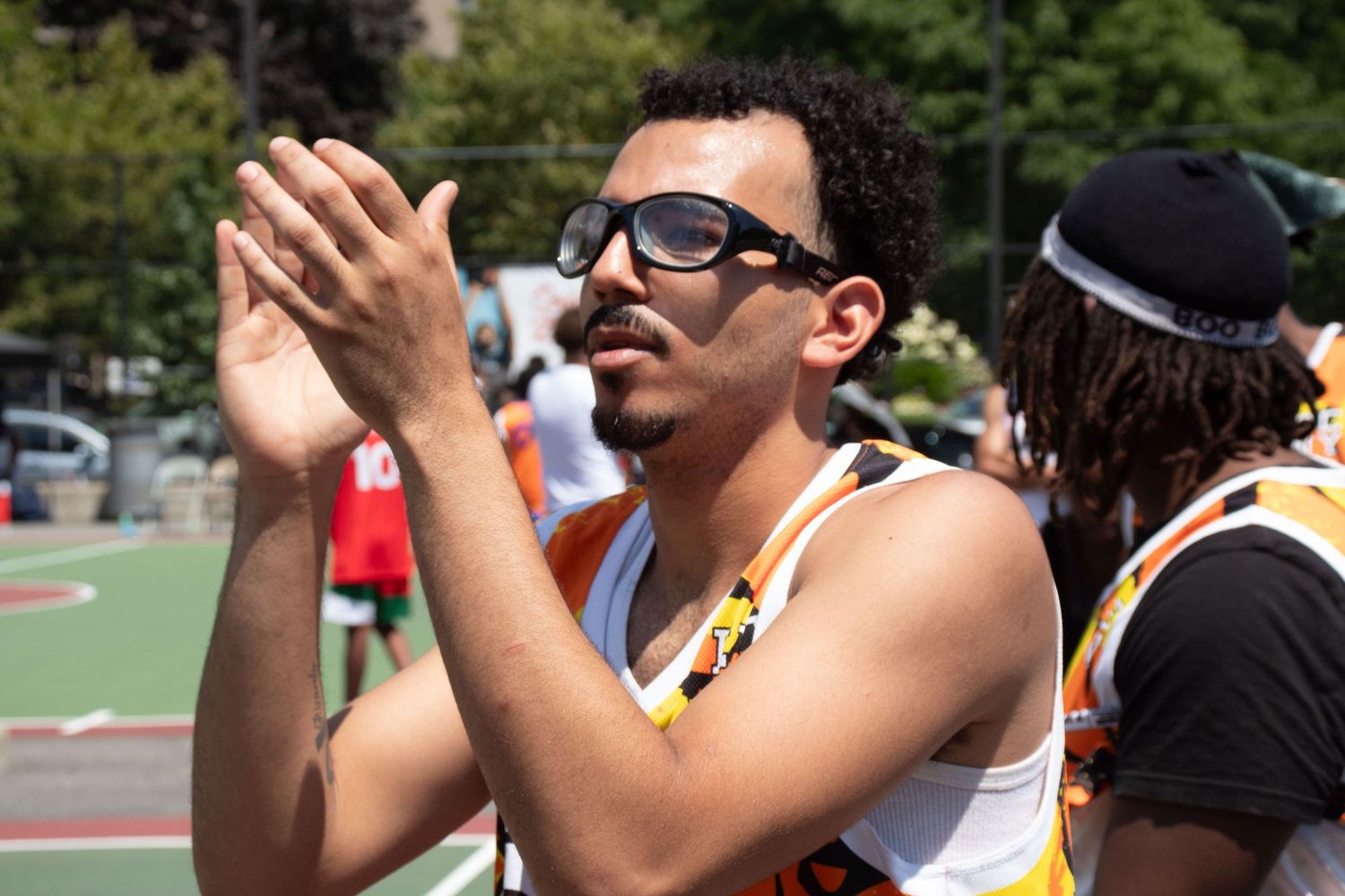 A sequence of sports fans watching and reacting with animated gestures and expressions during a game.