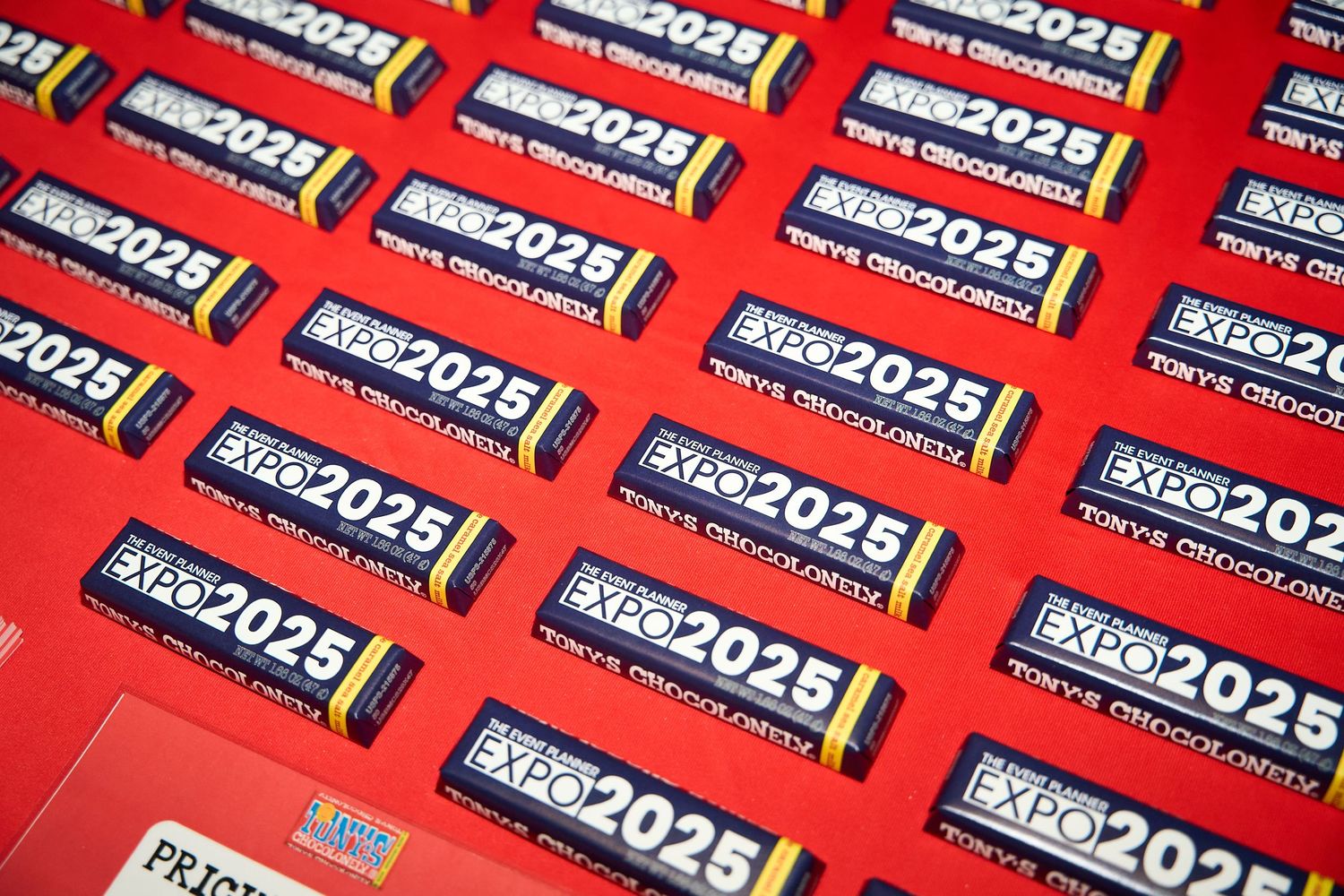 Multiple rows of black and white numbered stickers displaying '2025' arranged in a repeating pattern on a red background.