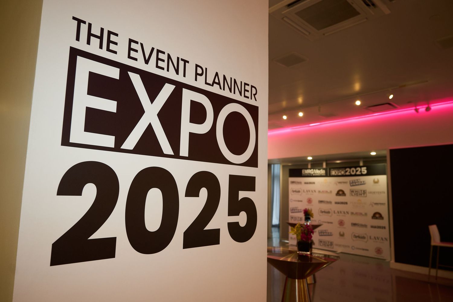 Event Planner Expo 2025 signage displayed at a professional conference venue with pink accent lighting.