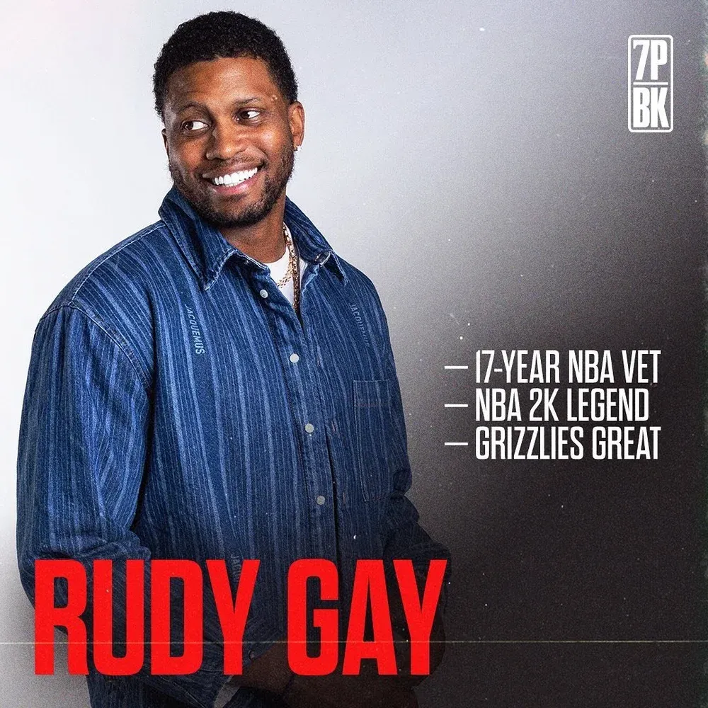 NBA veteran wearing a navy blue button-up shirt poses against gray background with career achievements listed.
